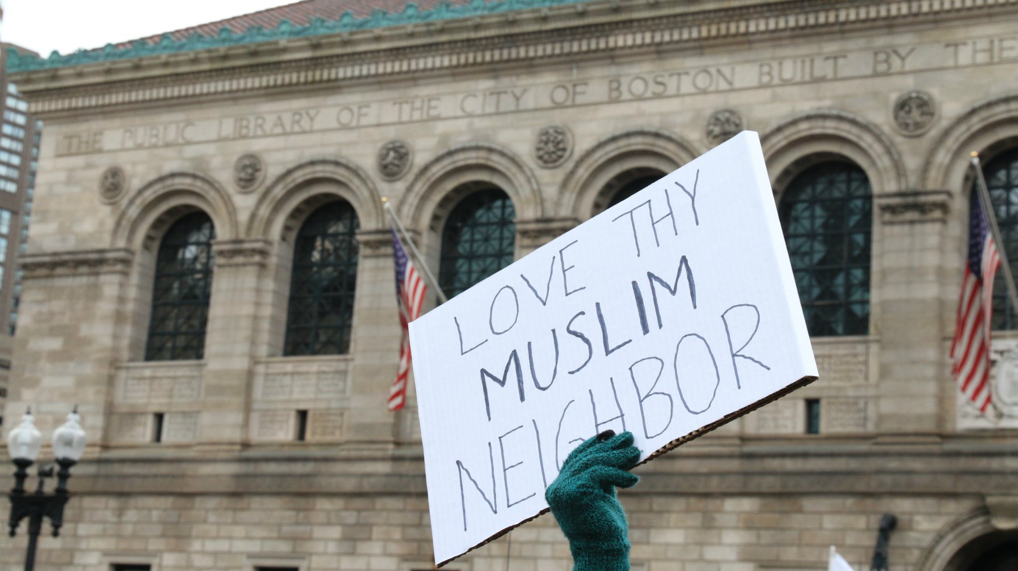  A sign reads “Love thy Muslim neighbor” at the protest in Boston’s Copley Square against President Donald Trump’s executive order on immigration. (Photo by Giulia Afiune/GroundTruth) 