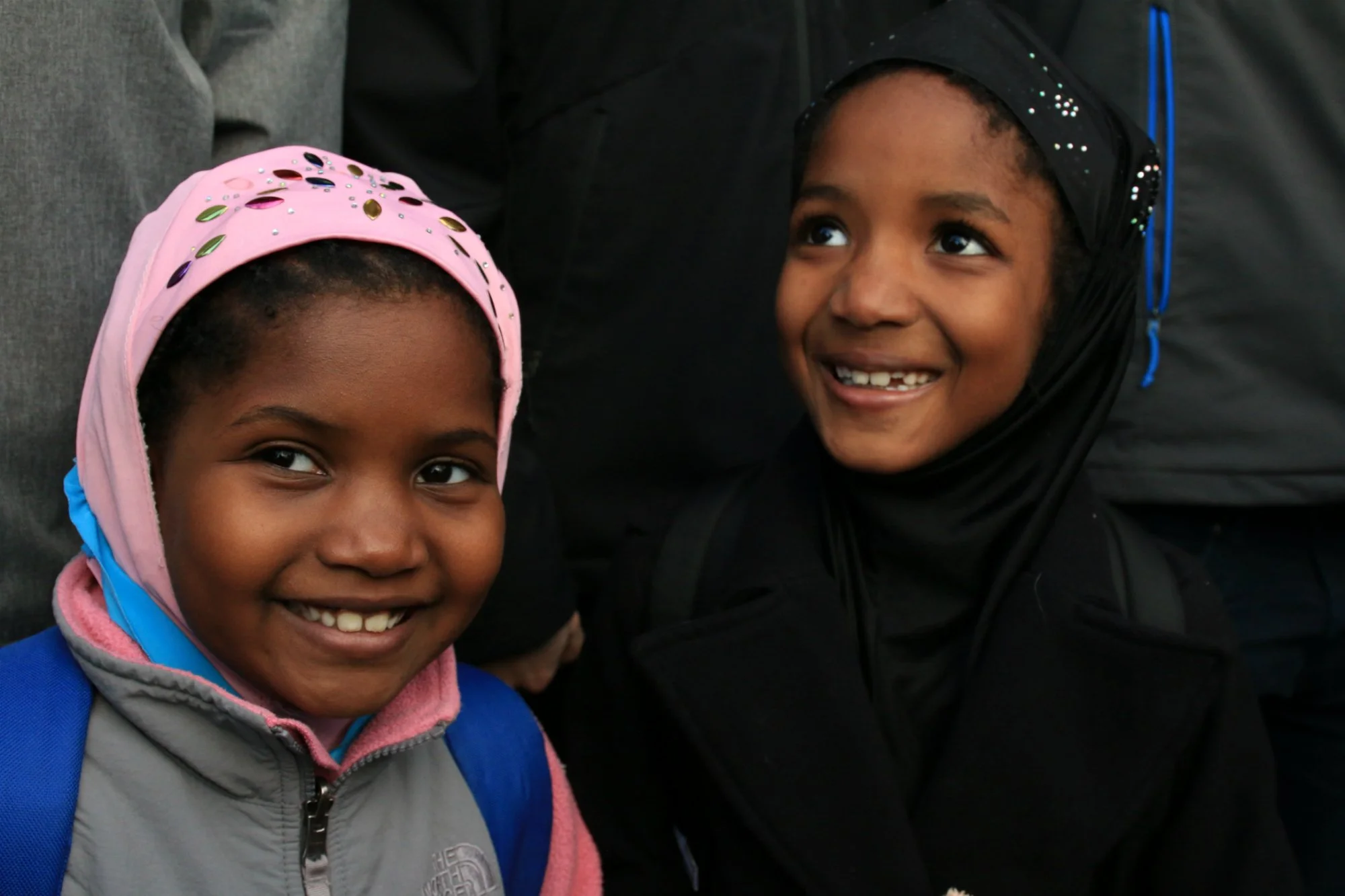  Two Muslim girls take part in protest against Donald Trump’s ban on seven majority-Muslim countries in Boston’s Copley Square on Jan. 29, 2017. (Photo by Giulia Afiune/GroundTruth) 