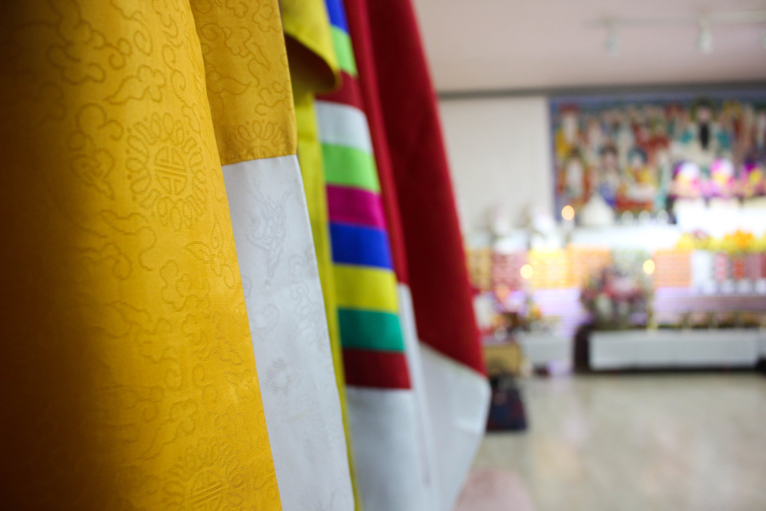  A collection of silk robes lines one of the walls. The five-hour ceremony is divided in shorter segments of about 30 minutes each. During each segment, the four shamans are believed to incarnate one of the many gods in Korean shamanism. Every time t