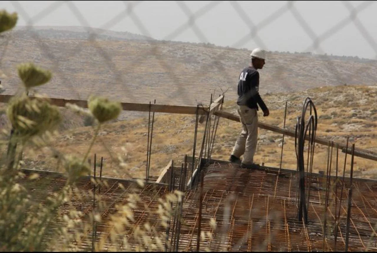 Tile by tile, Palestinians build Israeli settlements