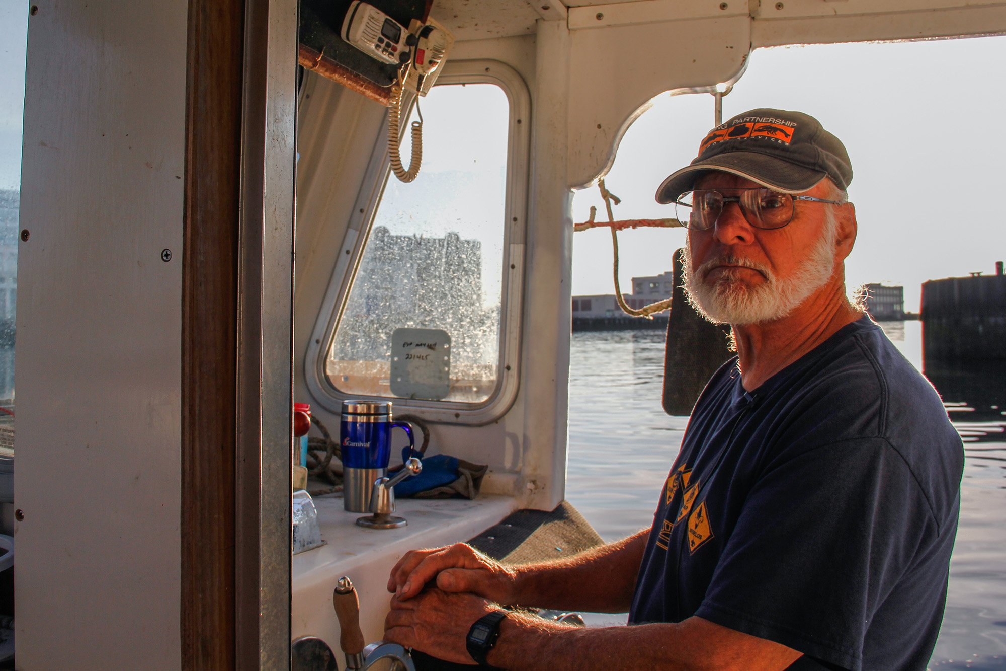   Captain Fred Penney, aboard his lobsterboat, The Sixpence. Captain Penney starts his day before dawn. (Ellen Kanzinger/GroundTruth)     
