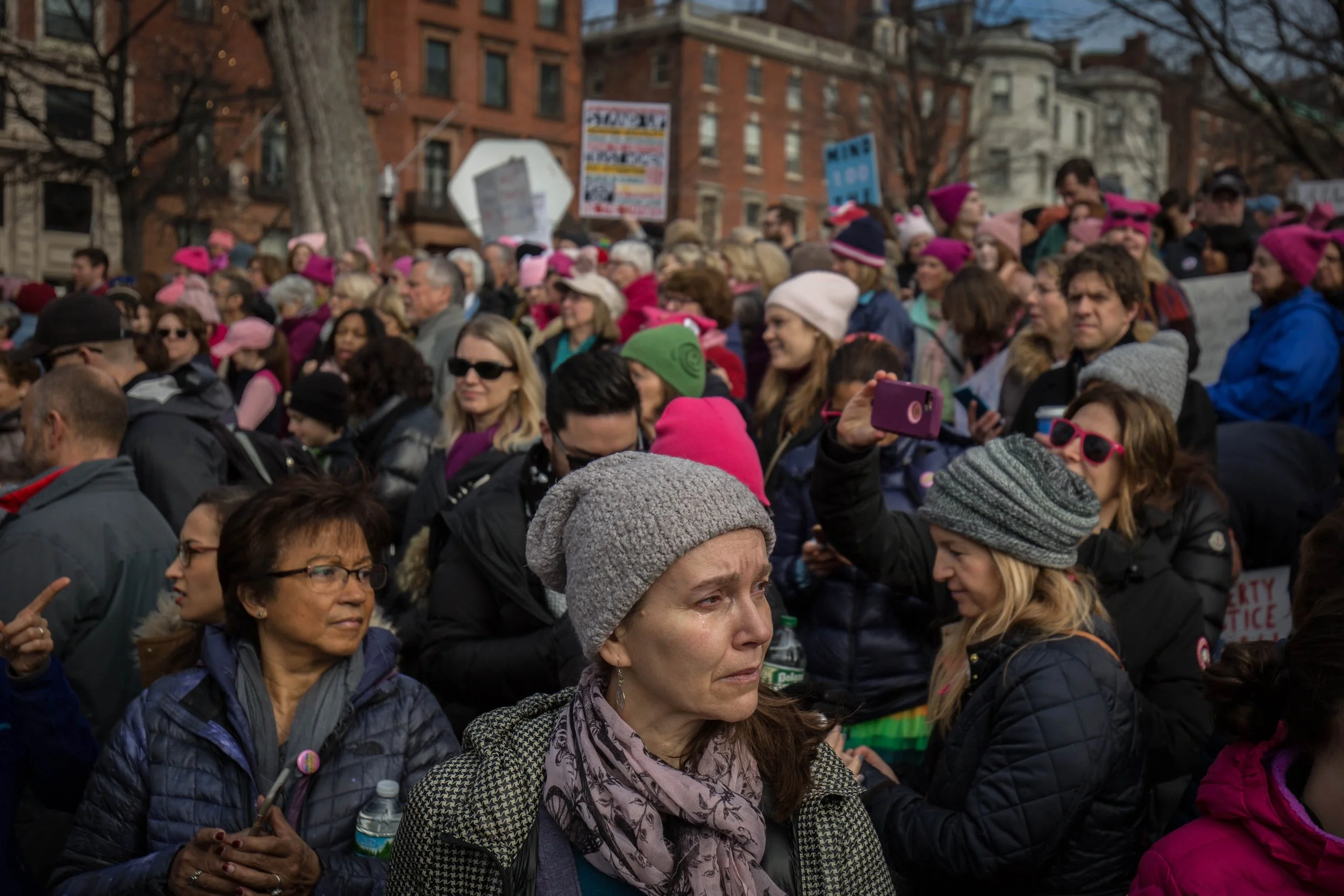  A woman sheds a tear as the song, “America the Beautiful: Together We Stand” plays in the Boston Common during the Boston Women’s March on Jan. 21, 2017. (Photo by Alastair Pike) 