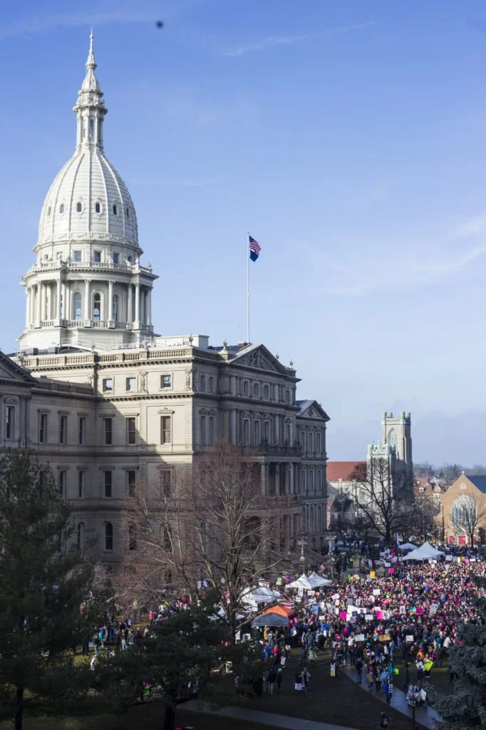   Thousands gather outside of the Michigan State Capitol Building for the Women’s March on Lansing in Lansing, Mich., on Saturday, January 21, 2017. (Photo by Brittany Greeson/GroundTruth)  