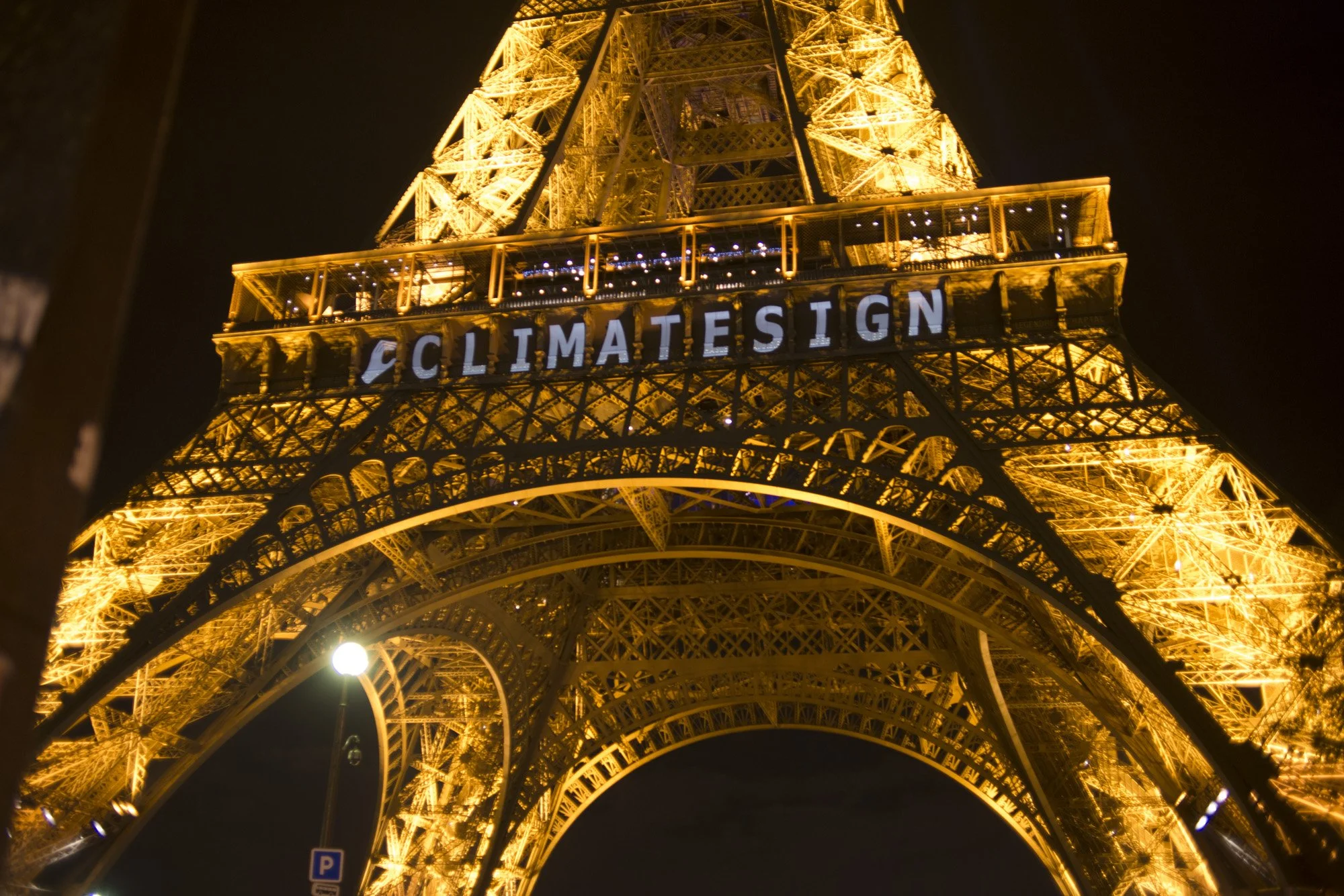 After attacks derailed first effort, Climate Sign shines on the Eiffel Tower