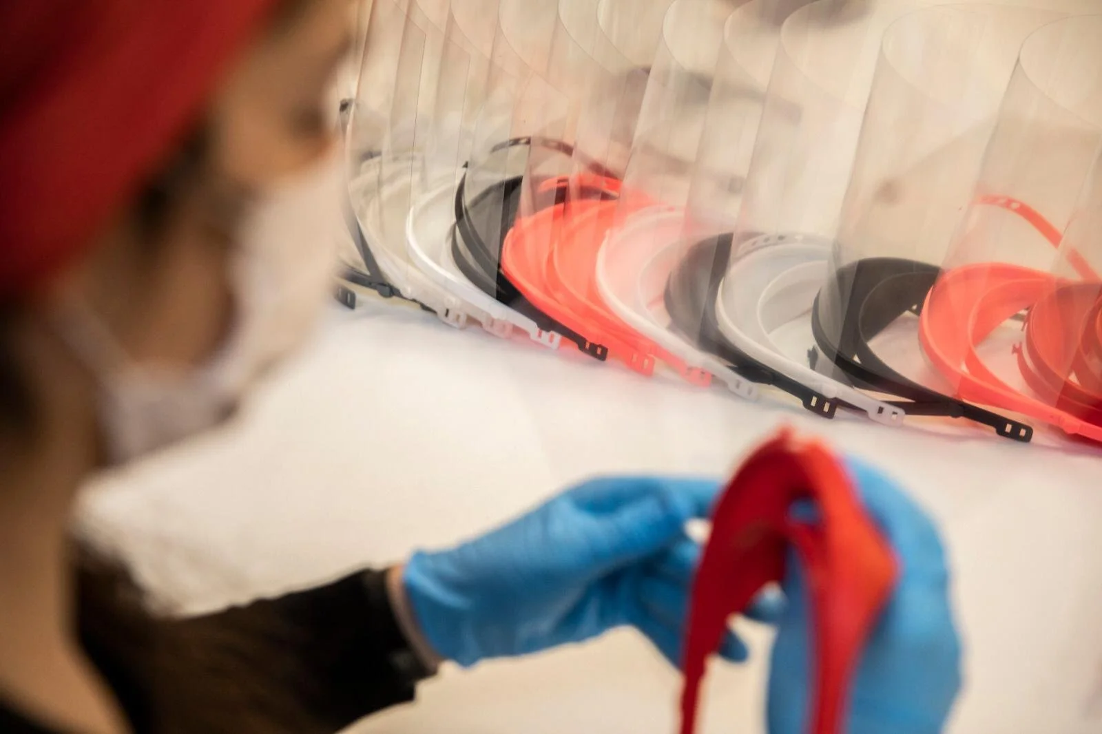   A volunteer assembles shields produced by the maker community of Barcelona. (Photo by Santi Palacios)     