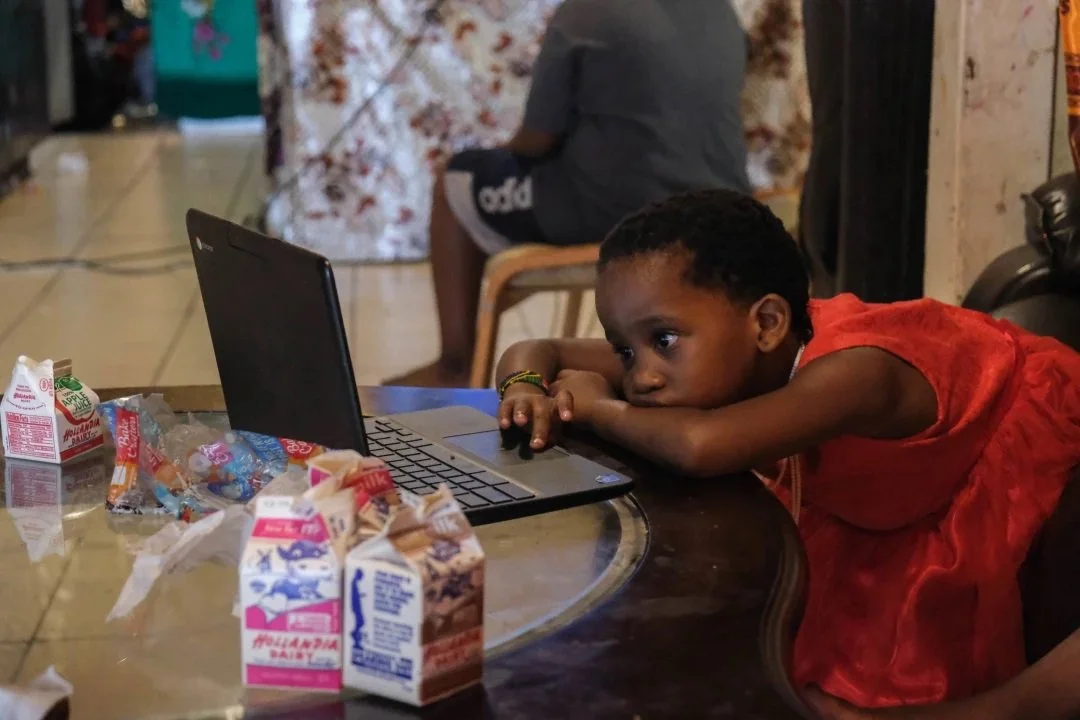  Famo’s niece, Safiya, tunes into her Zoom class at the end of the school day. For elementary students like Safiya the day begins at nine and ends at noon. Safiya is one of Musa’s sister’s nine children. Musa watches the children most weekdays while 