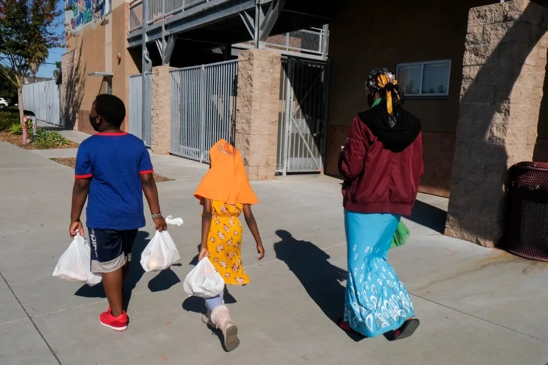  Musa, Osman, 10, and Sadiya, 7, walk to a San Diego Unified School District campus down the street (Photo by Aryana Noroozi/GroundTruth) 