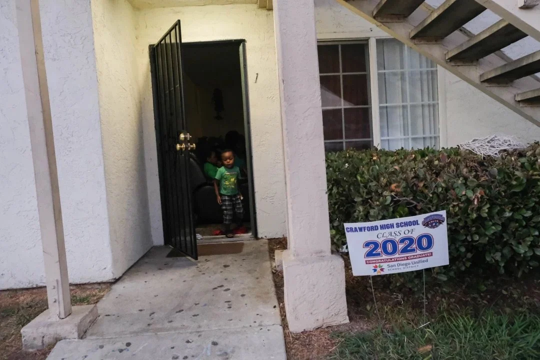  Denis Sindayigaya, 3, emerges from the family apartment to play outside at dusk. (Photo by Aryana Noroozi/GroundTruth) 