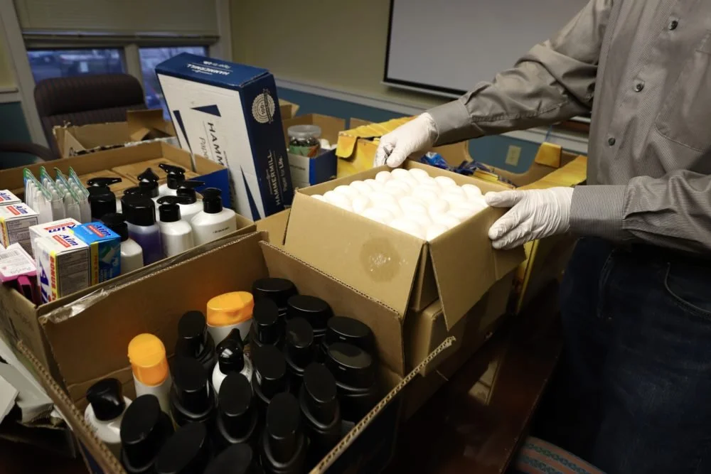  Columbus House Chief Development Officer John Brooks opens up a box of supplies donated to the Columbus House shelter in New Haven, Conn. (Photo by Chris Ehrmann/GroundTruth) 