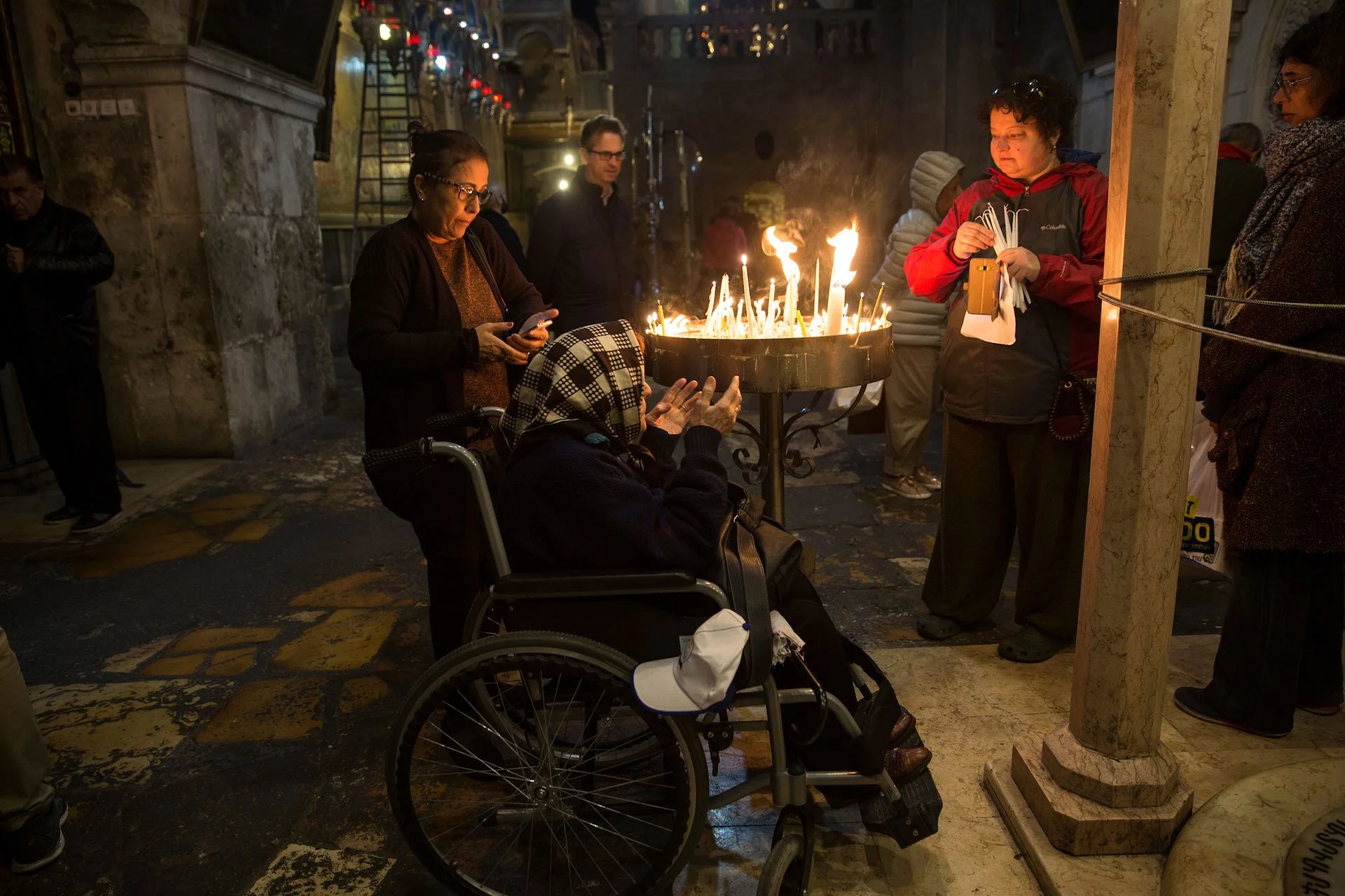 Iraqi Christians Ester Shair ,82, is seen in her wheel chair as she visits the Church of the Church of the Holy Sepulchre in the Old City of Jerusalem during Good Friday on April 30,2018.The family left Baghdad after the Gulf War and some family memb