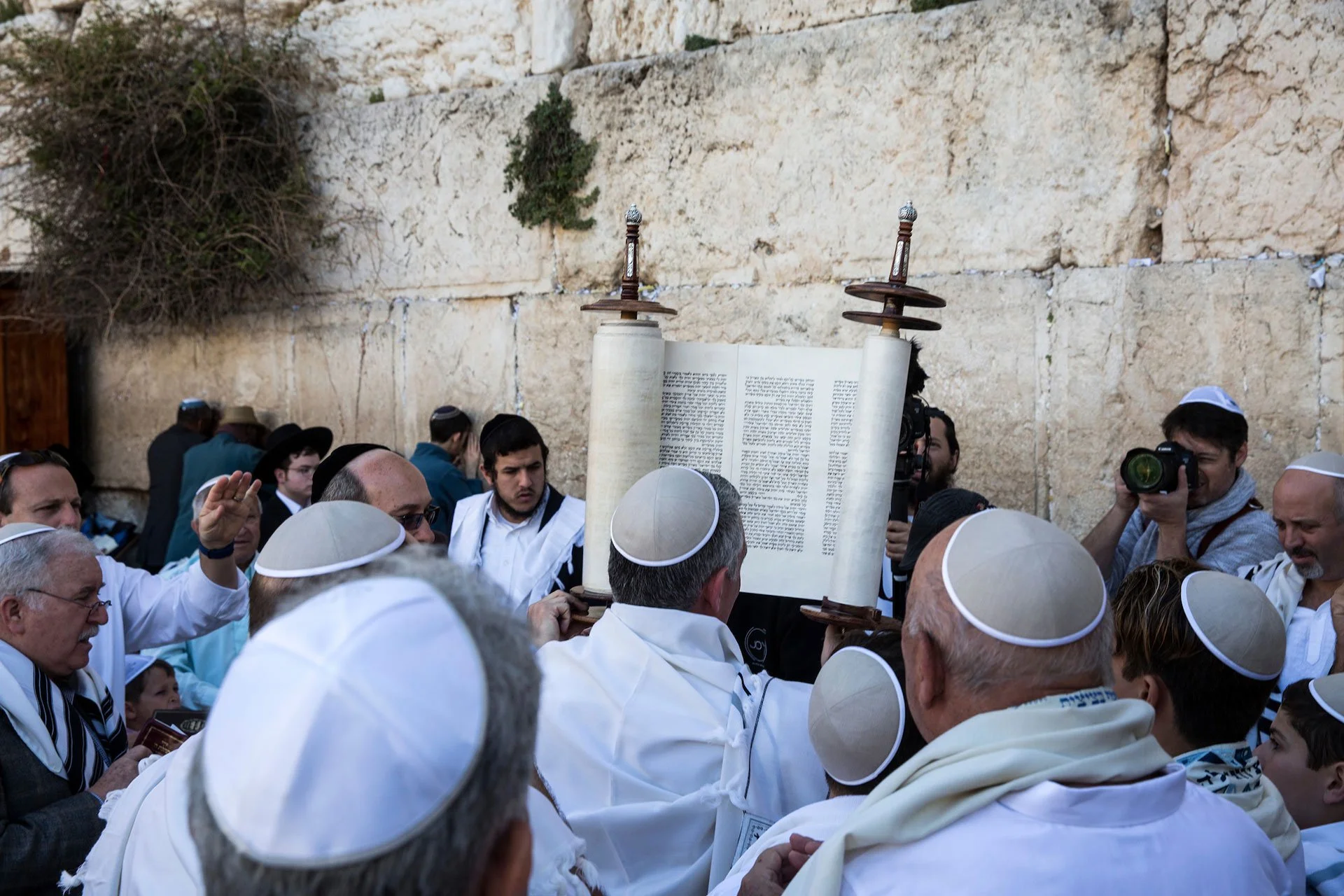 A Torah scroll is seen during a Bar mitzvah of a 12 year old boy as Ultra-Orthodox Jewish men of the Cohanim Priestly caste, many covered in their prayer shawls during a blessing during the Jewish holiday of Passover at the Western Wall, the holiest 