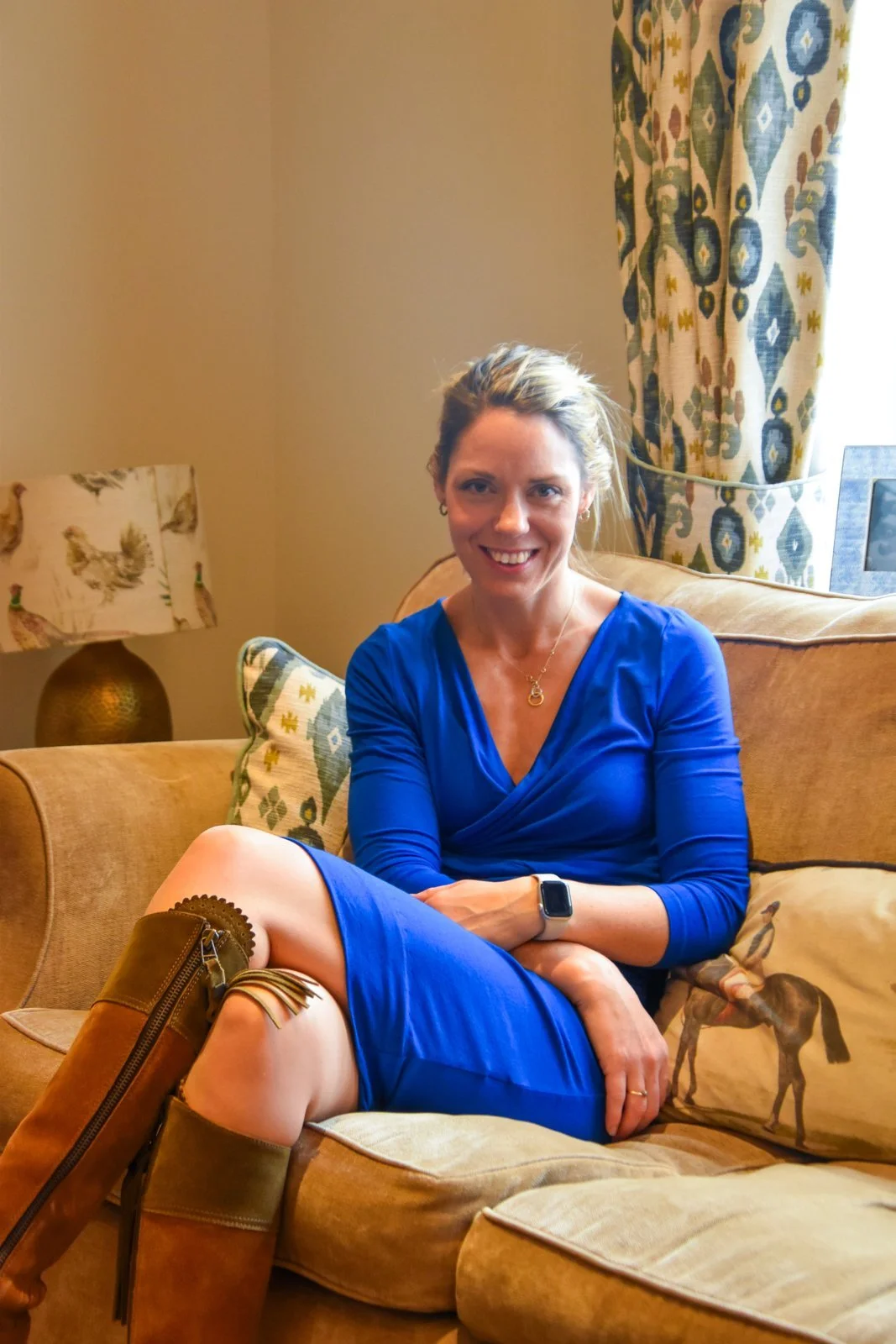 Samantha Seaman, People Strategist, sitting on a sofa smiling