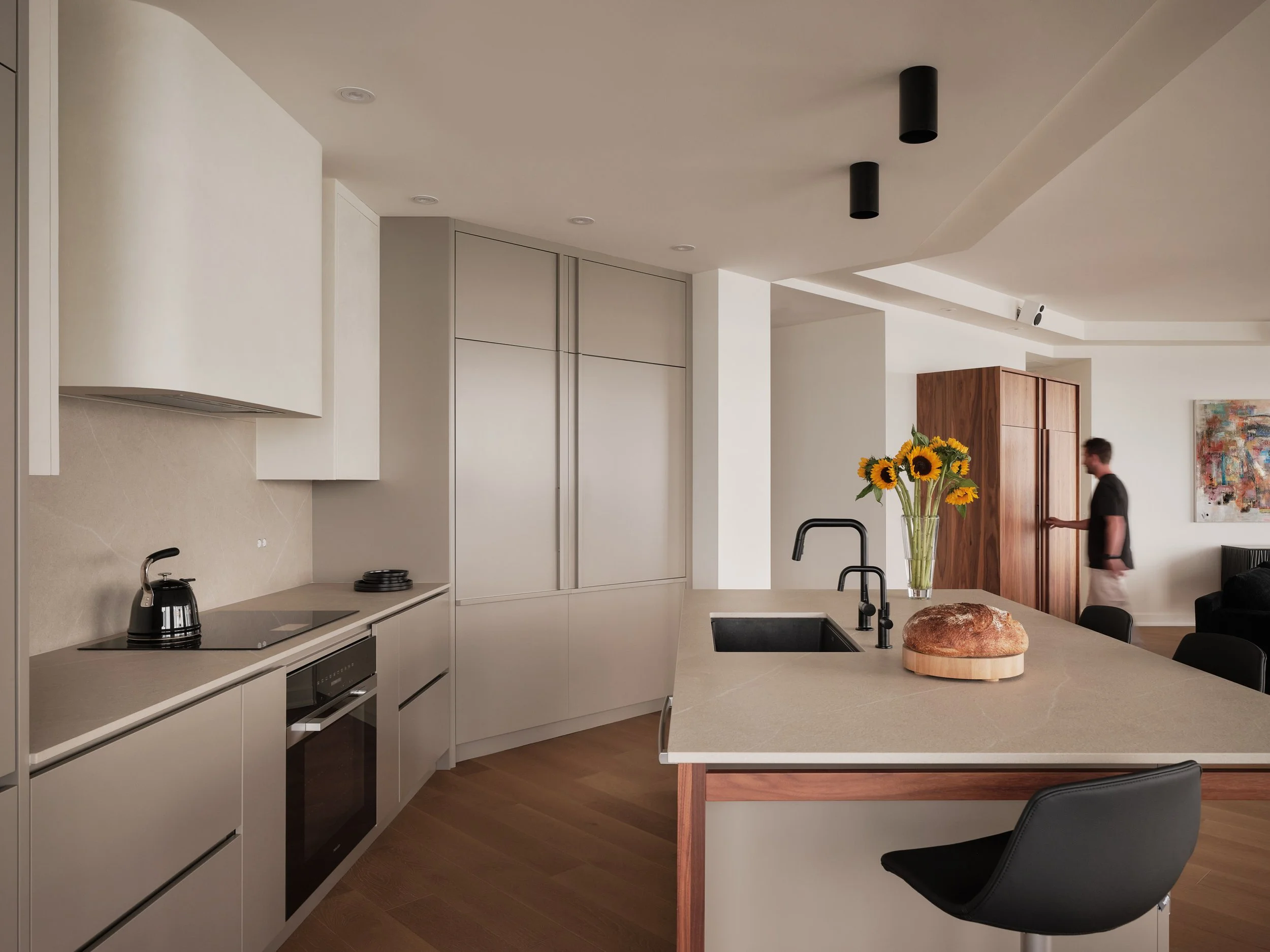 Custom-made walnut wine cellar integrated into the living space of a contemporary apartment