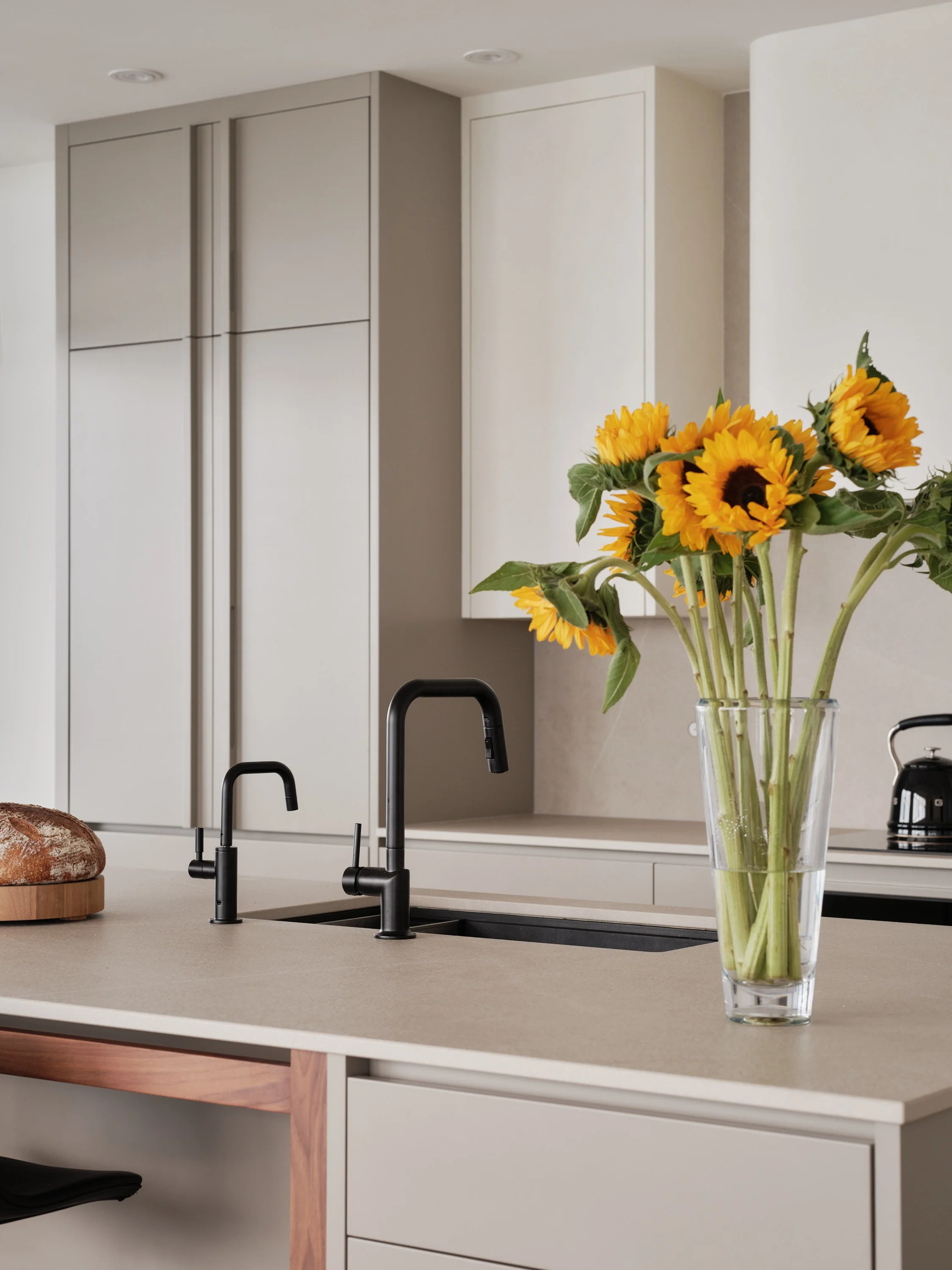 Custom-made kitchen island with a light-colored worktop and natural wood details