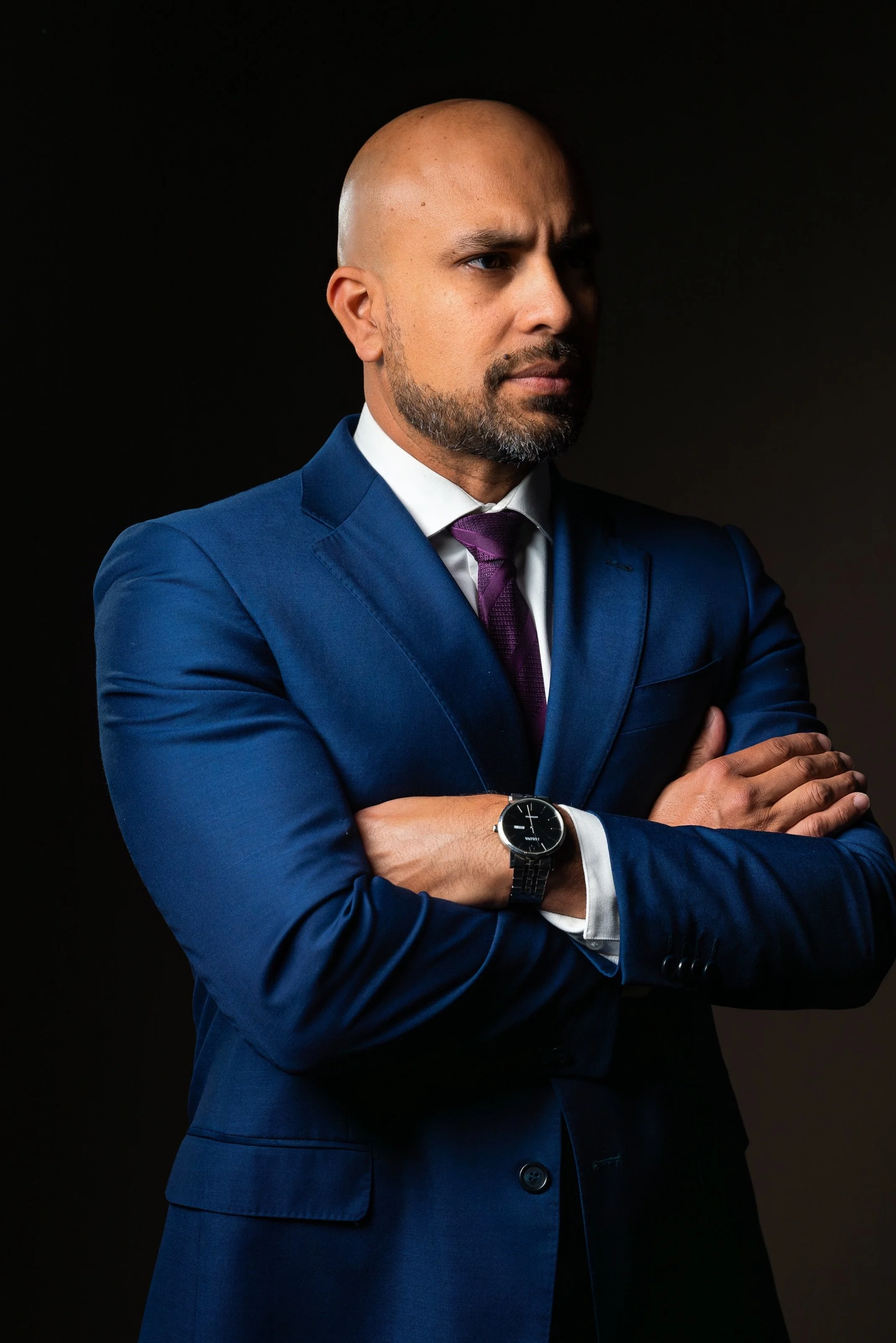Bald man with beard in suit and tie smiling