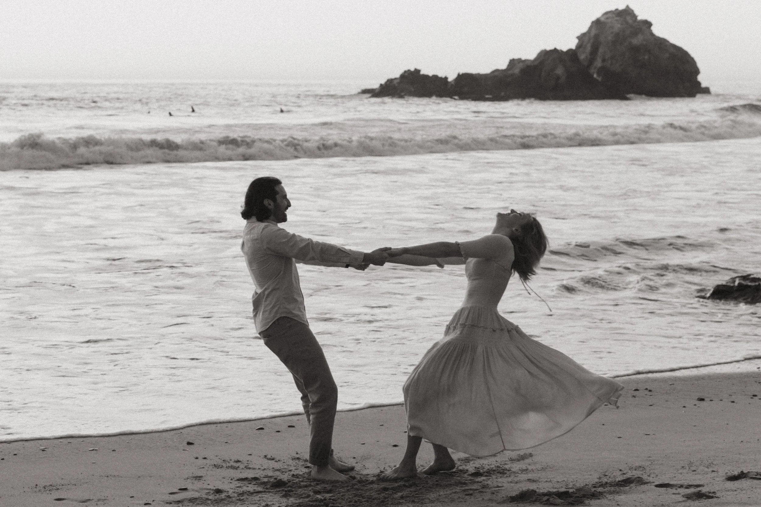 couple spinning on pfeiffer beach after getting engaged