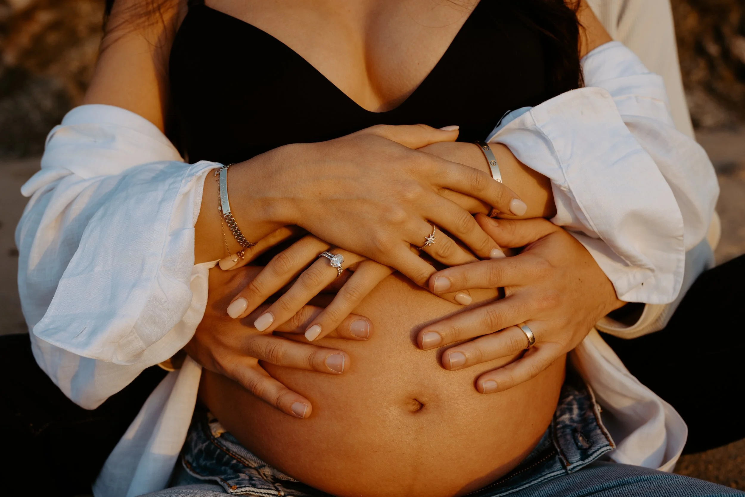 maternity session at garrapata beach of couples hands on belly