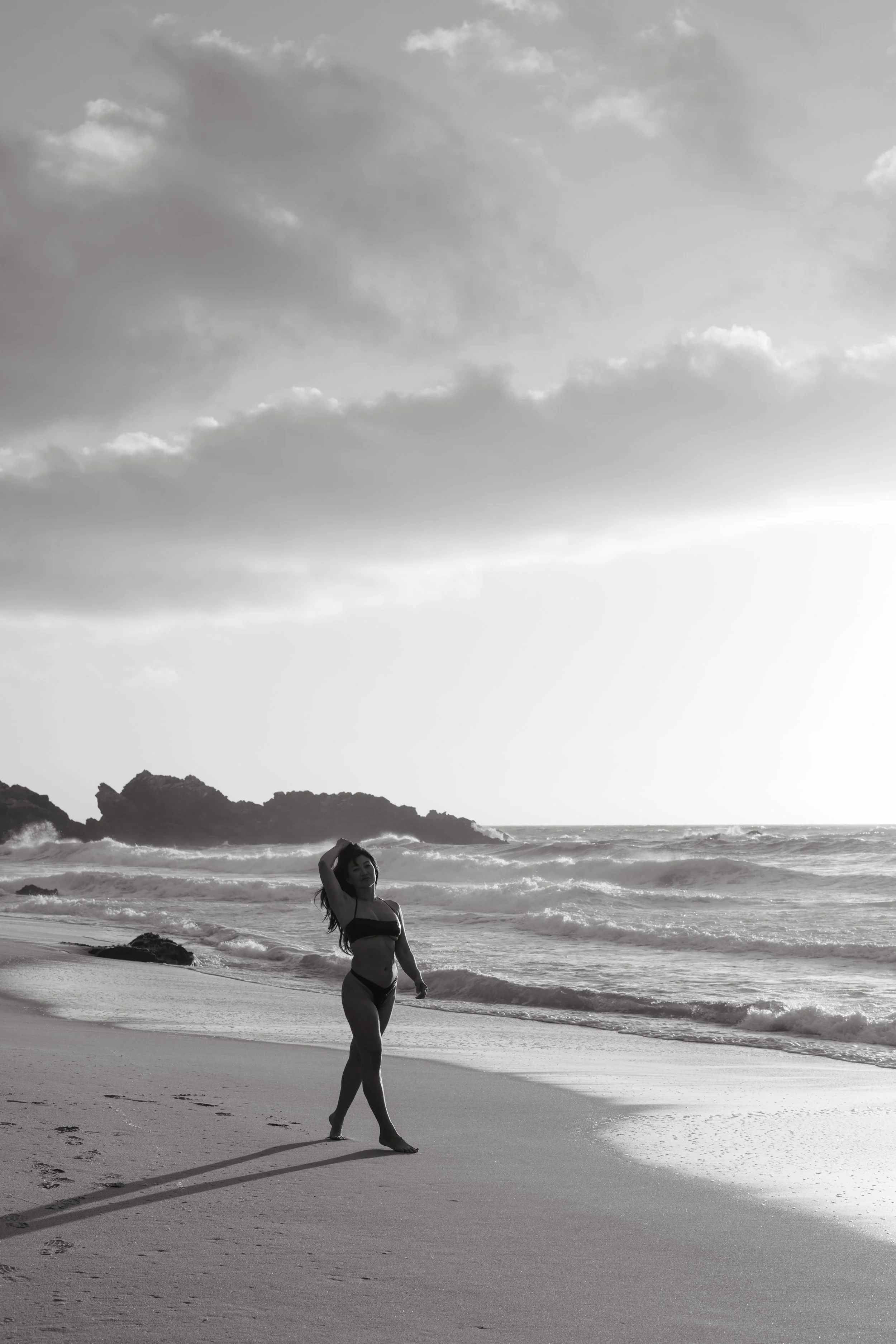 model walking down beach for monterey boudoir photos