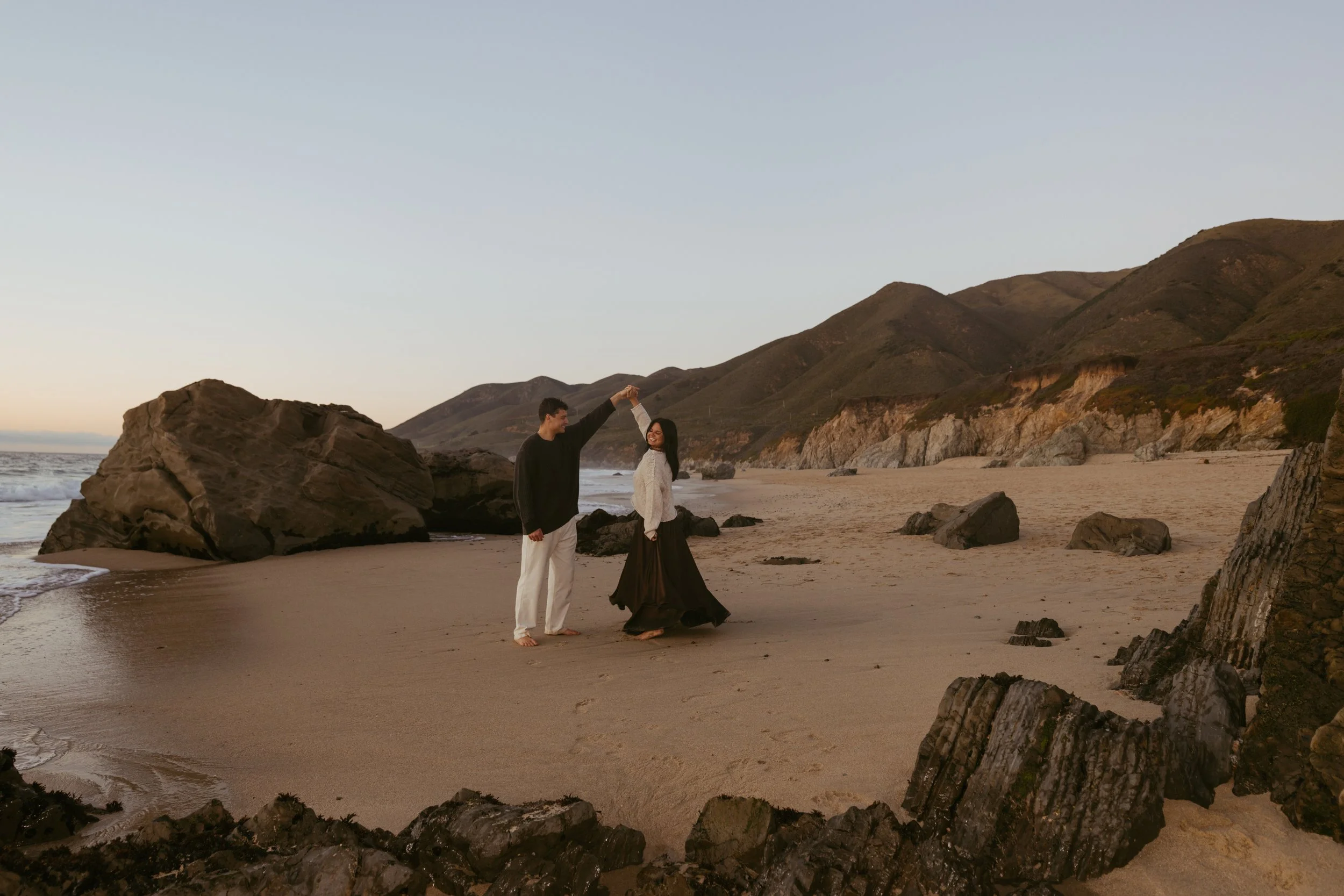 man and woman dancing after surprise proposal in carmel by the sea