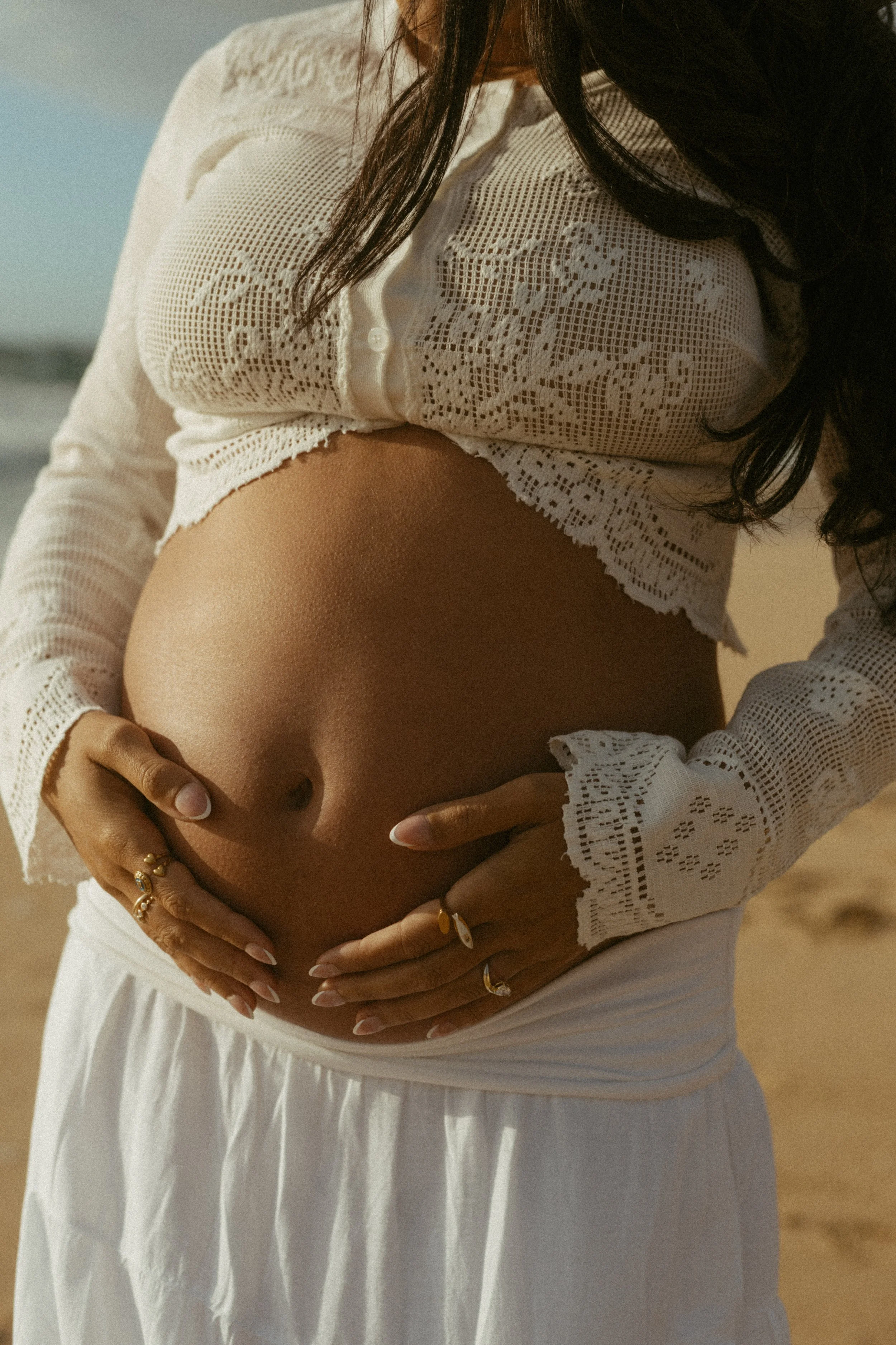 maternity photoshoot belly close up shot with rings on