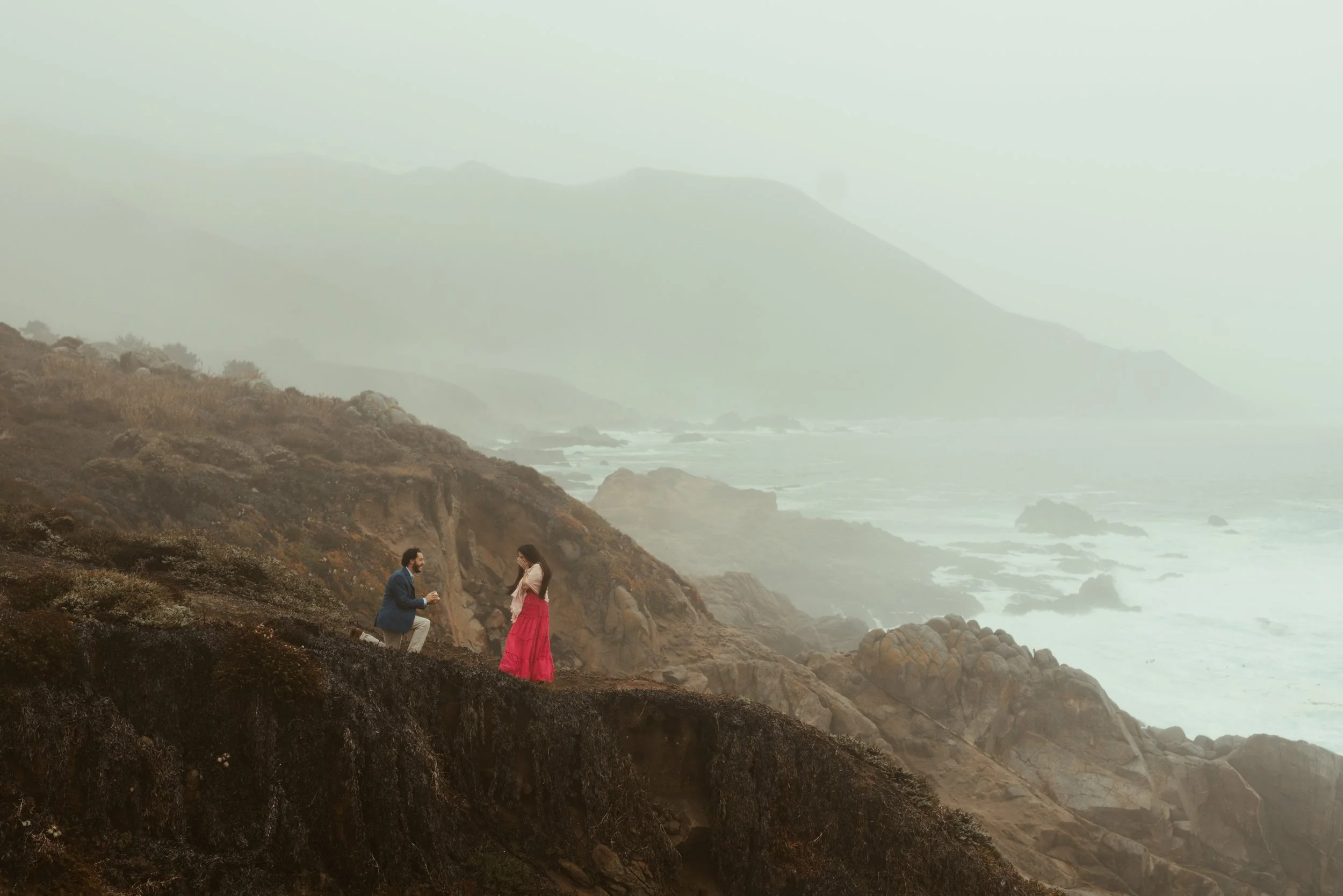 man proposing to his girlfriend cliffside at Garrapata State Park in Carmel California