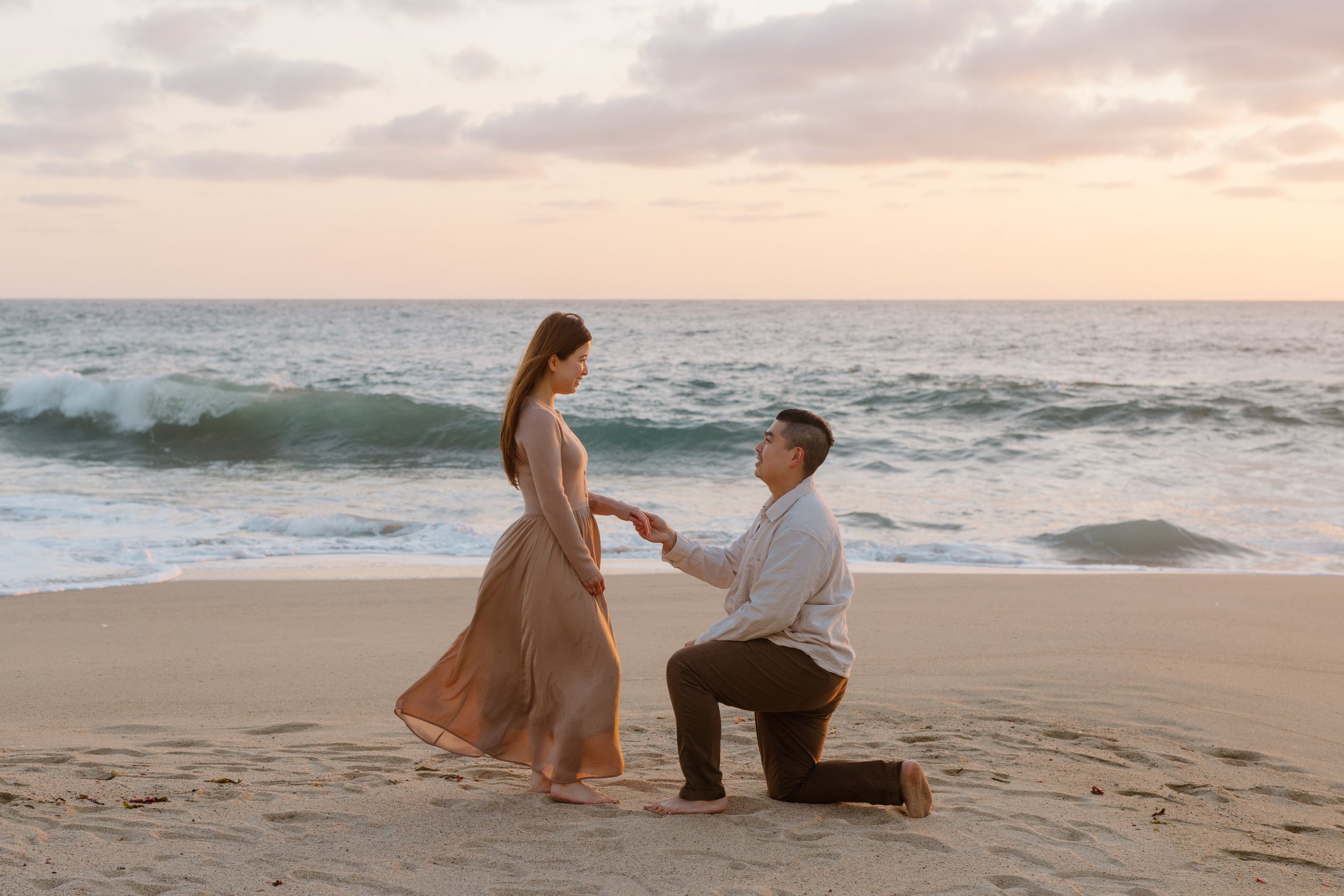 man proposing at sunset on garrapata beach