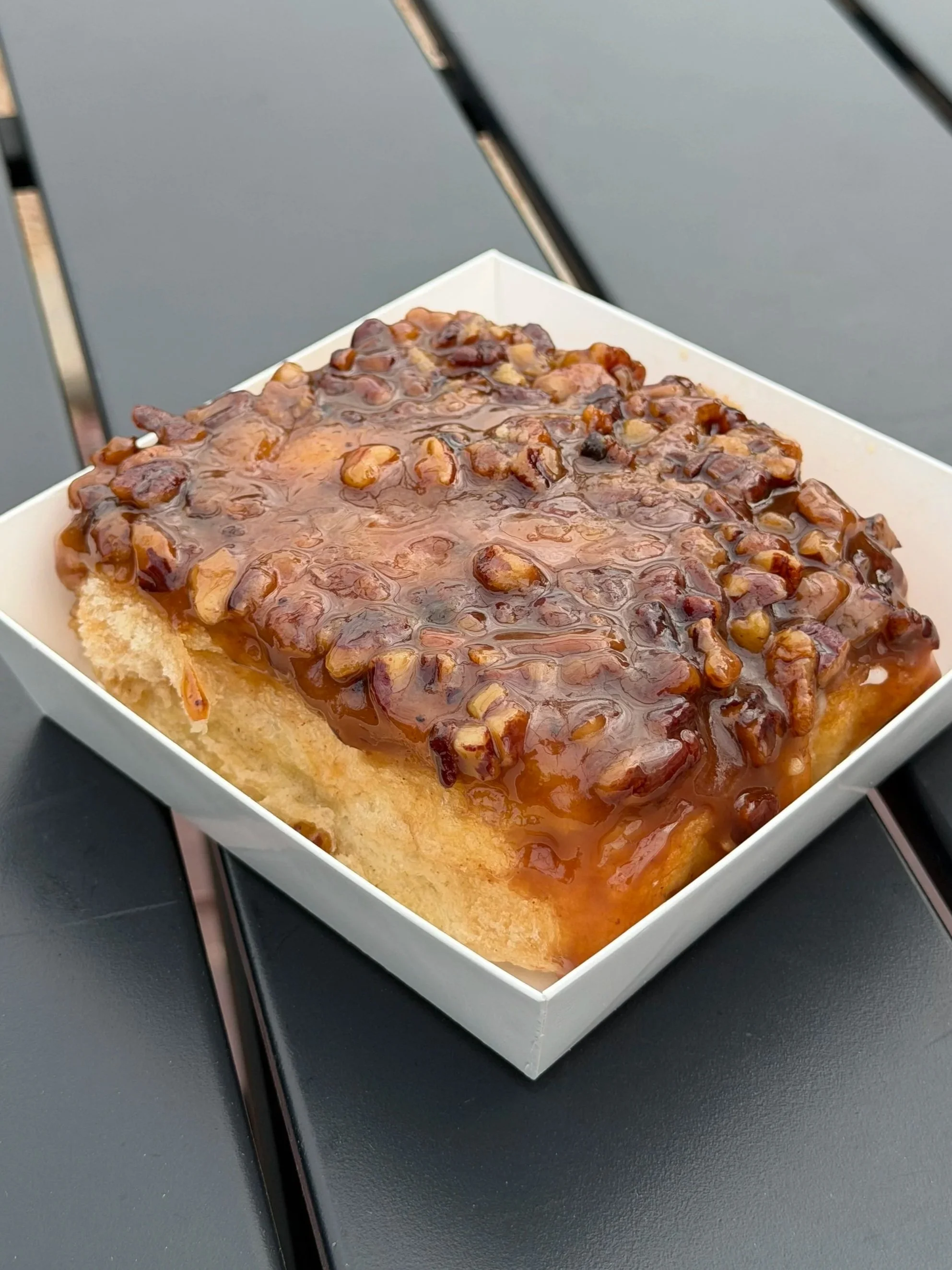 Caramel pecan sticky bun from Salty Blonde Bakery topped with caramel and pecans
