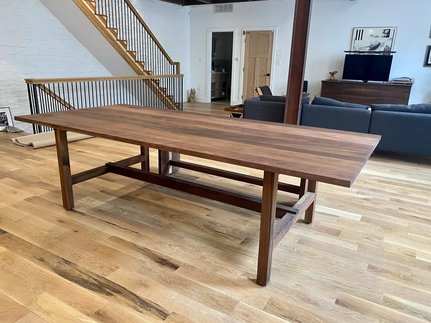 Custom bespoke walnut dining table, hand rubbed oil natural finish, modern trestle style dining table, hardwood, design in Midway delivered in Park City.