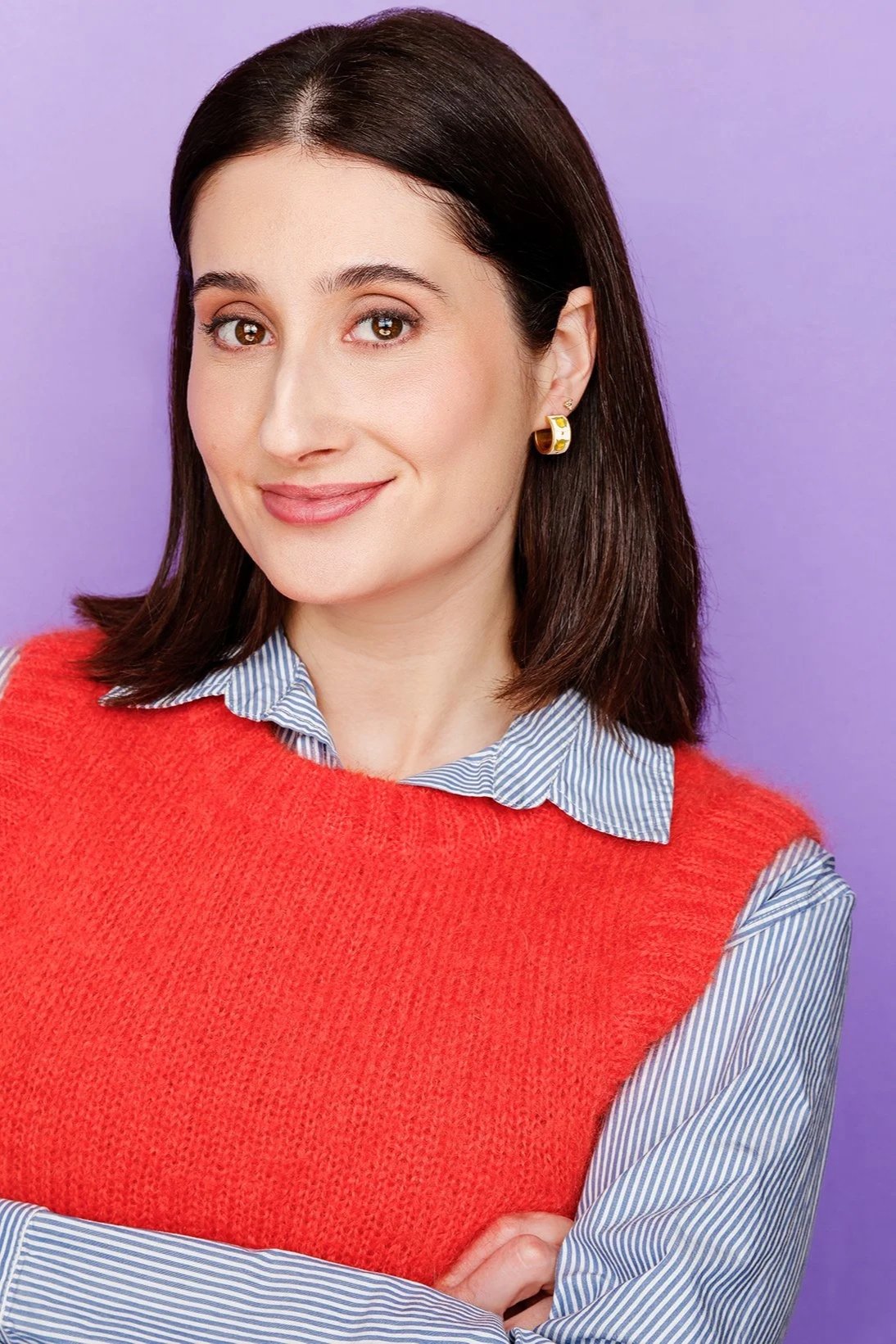 Headshot of Brooke standing with her arms crossed