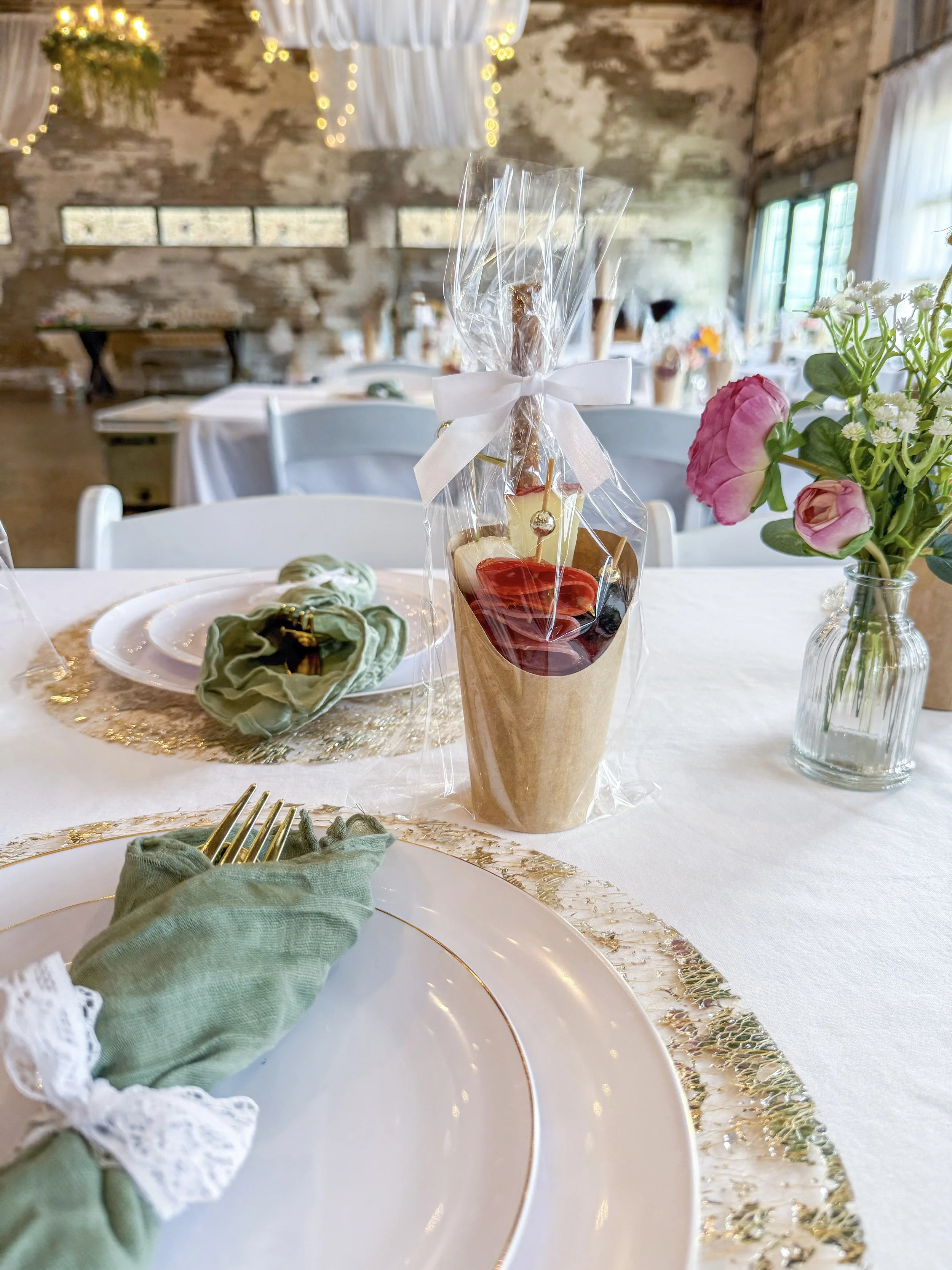 Wrapped charcuterie cup filled with food displayed on a table
