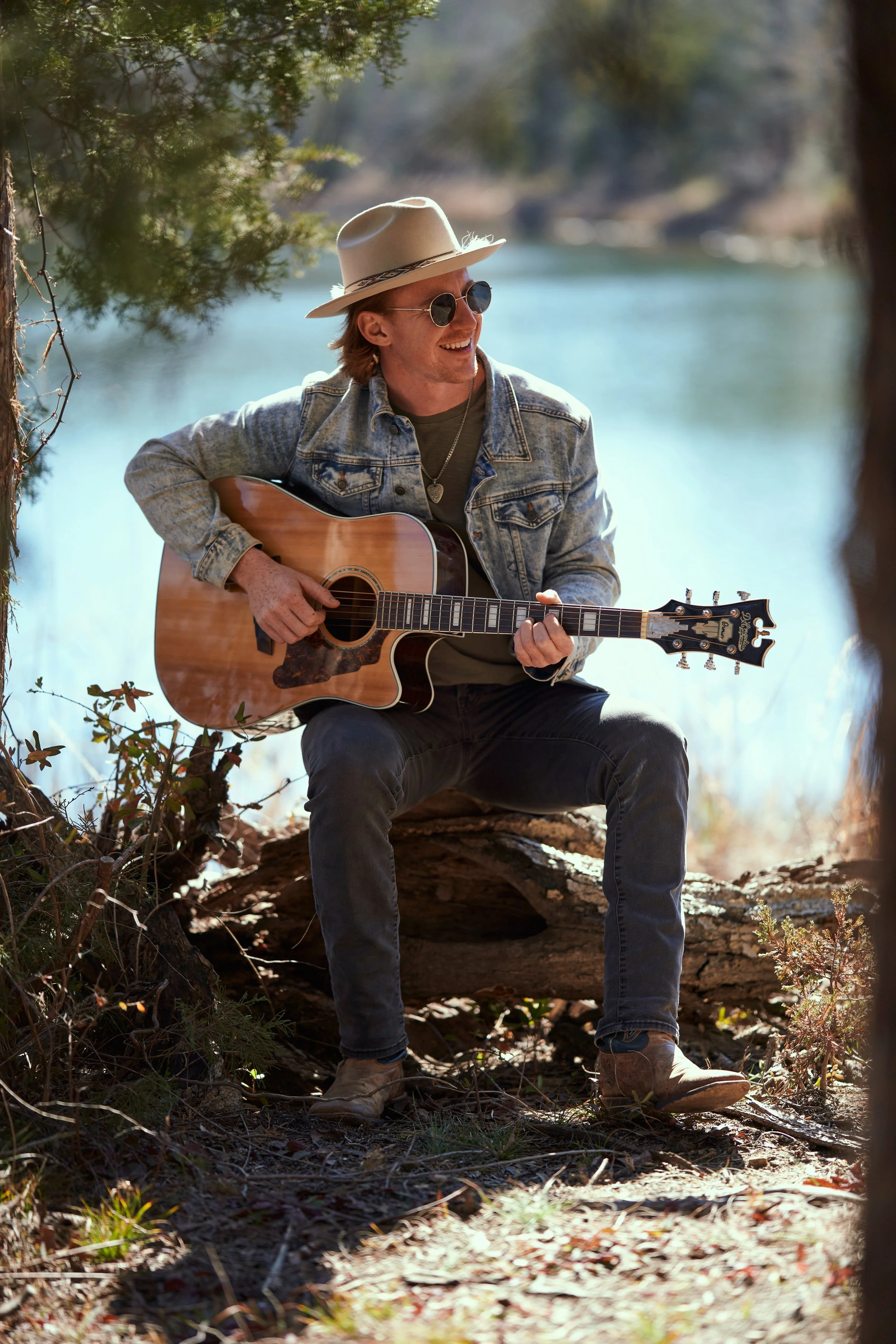 country artist singing by water with guitar.jpg