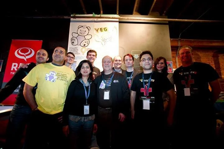 Volunteers and participants gathered for a group photo in front of the event banner