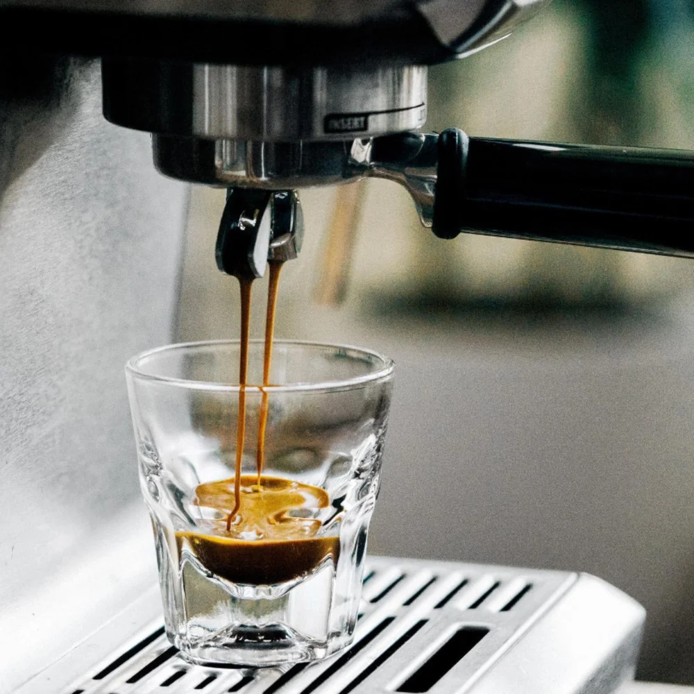 Espresso pouring from the machine into a glass