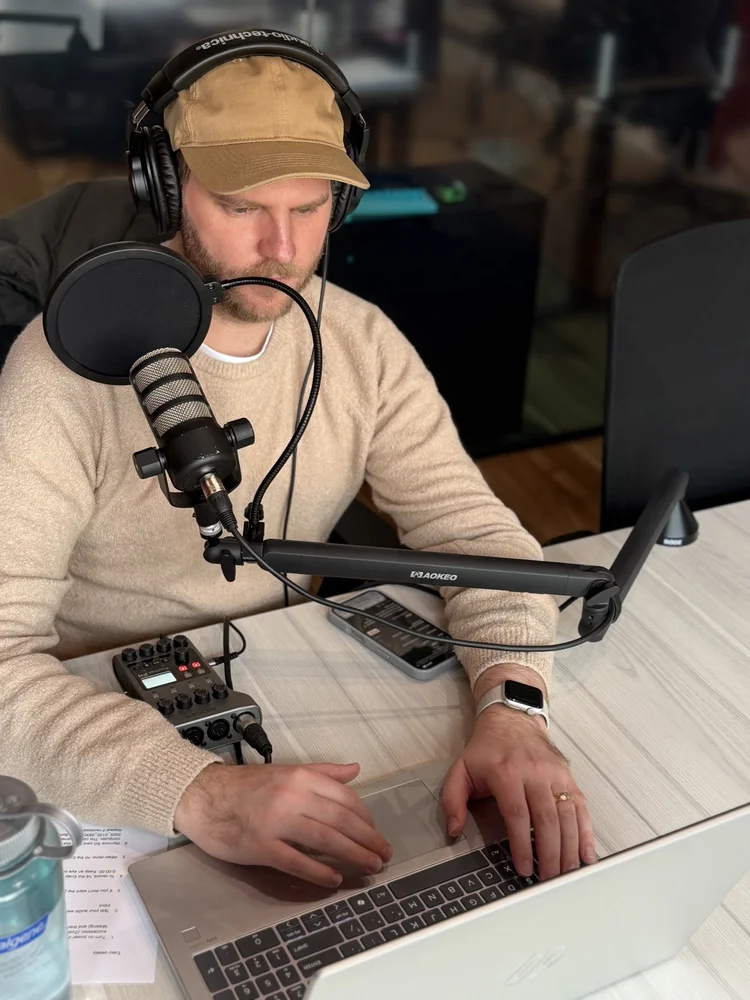 Nick Ross of reVerb recording voiceover narration at a microphone and laptop