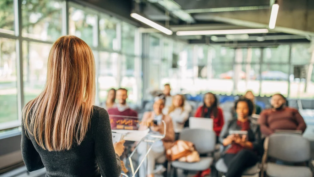 Team member presenting to colleagues in an open office