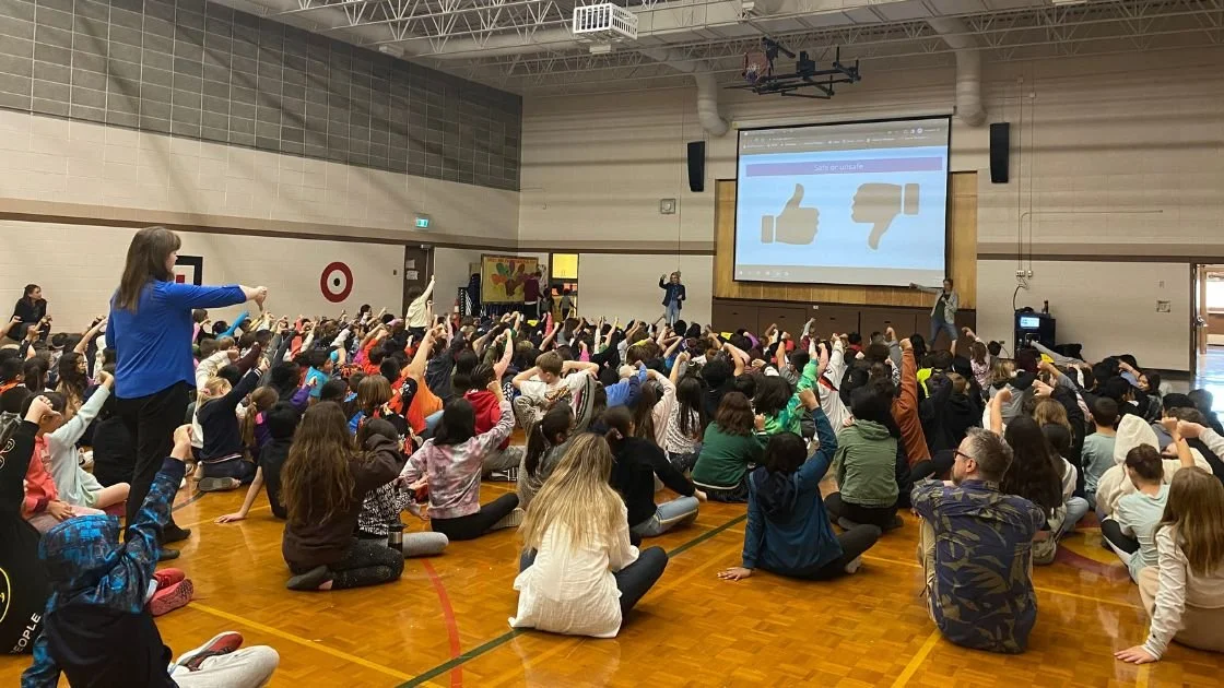 Students taking part in a presentation at a school assembly