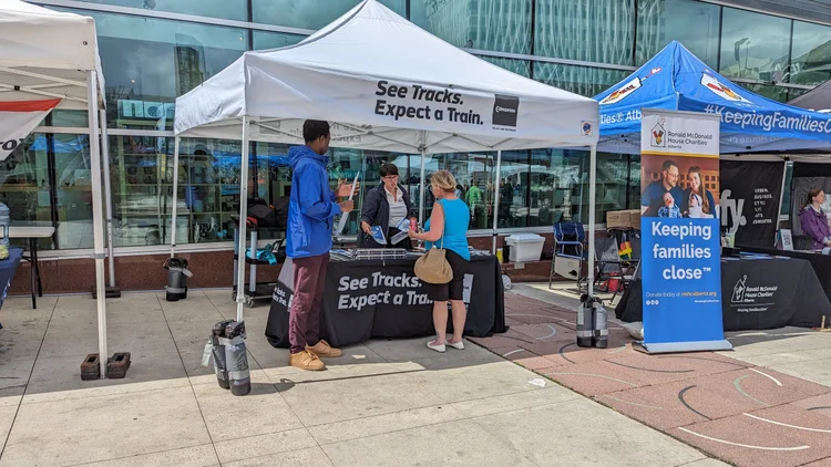 Visitors at the street team table during an indoor community event