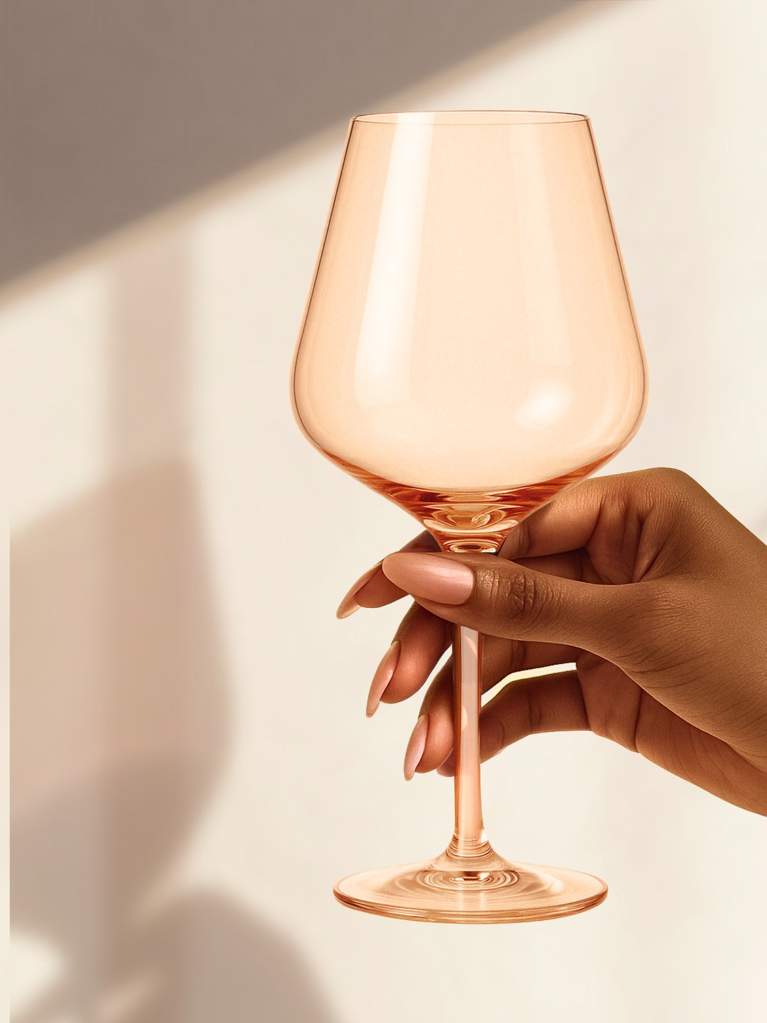 Hand-blown crystal wine glasses with a soft peach glow. The Naked Peach set of 4 is made for warm baths, quiet nights, and winding down, no apologies needed.