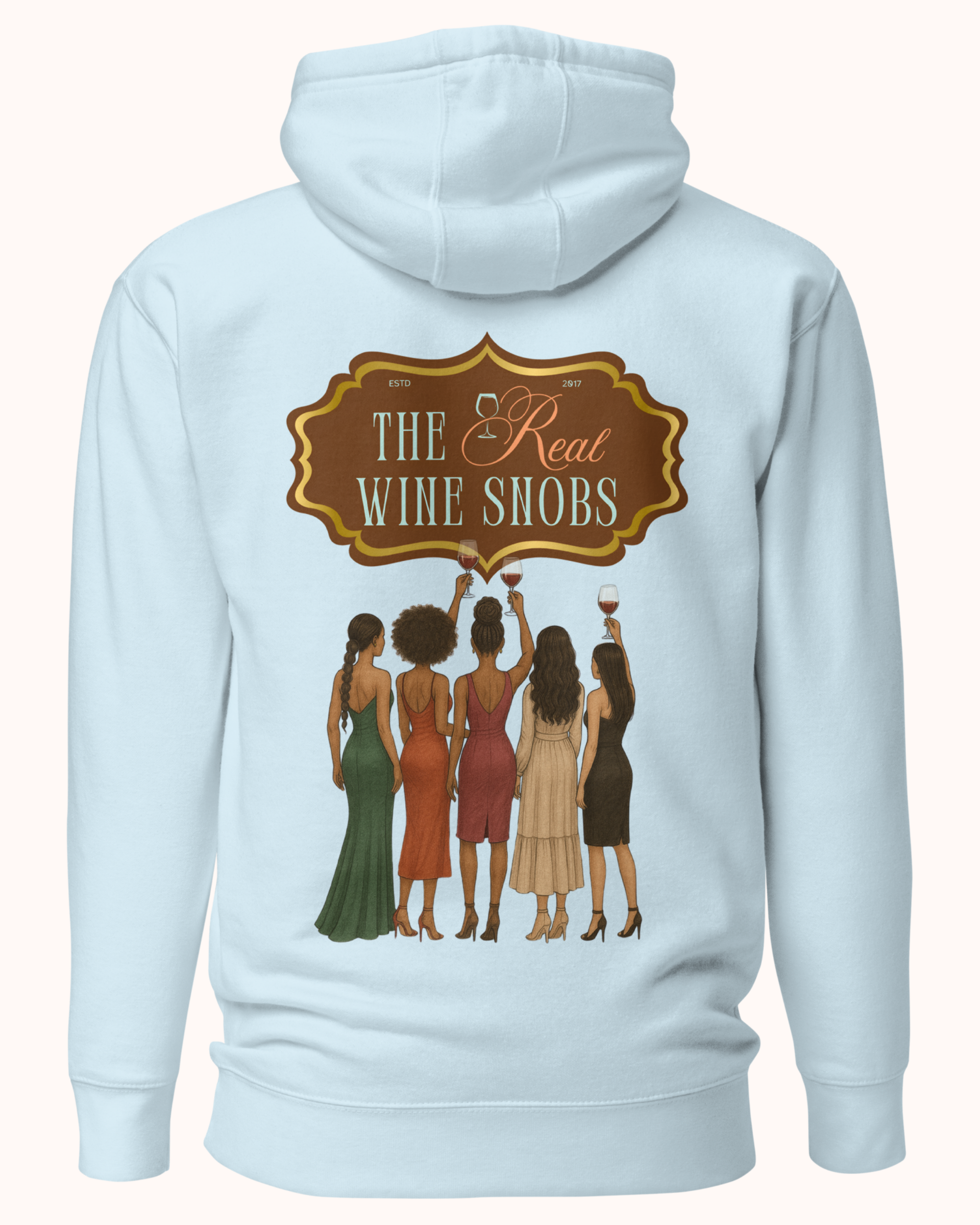 The Real Wine Snobs Snob Hoodie features women raising wine glasses beneath the brand crest. A fleece-lined hoodie designed for tastings, girls’ nights, and wine lovers with a little attitude.