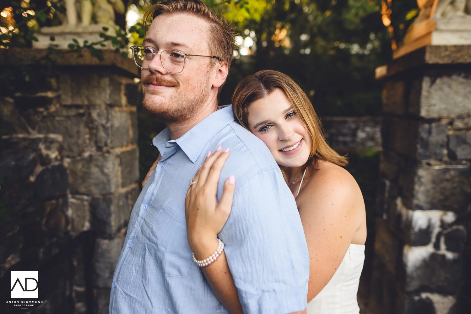 	Engagement ring detail as she rests her head on his shoulder smiling — New Castle County engagement photographer