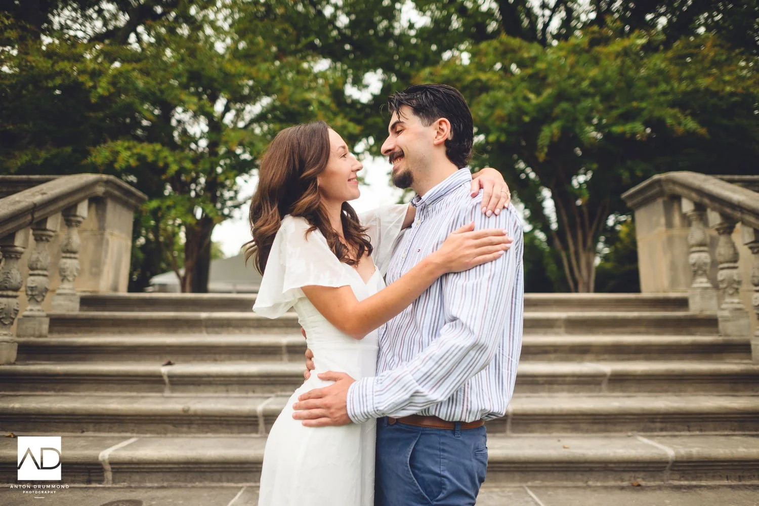 Emily and Joe stealing glances at each other on the stone balustrade steps — Montgomery County wedding photographer