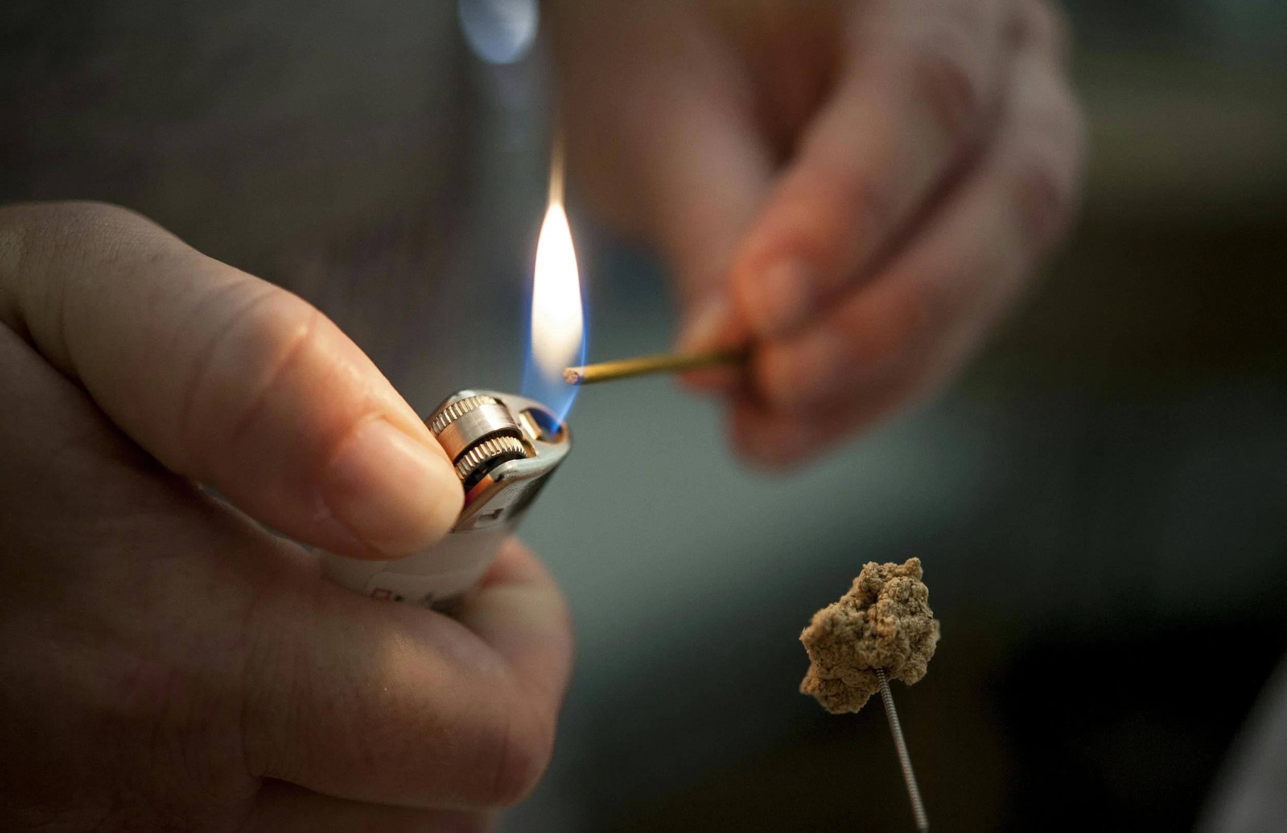hands lighting a incense and moxa on needle image