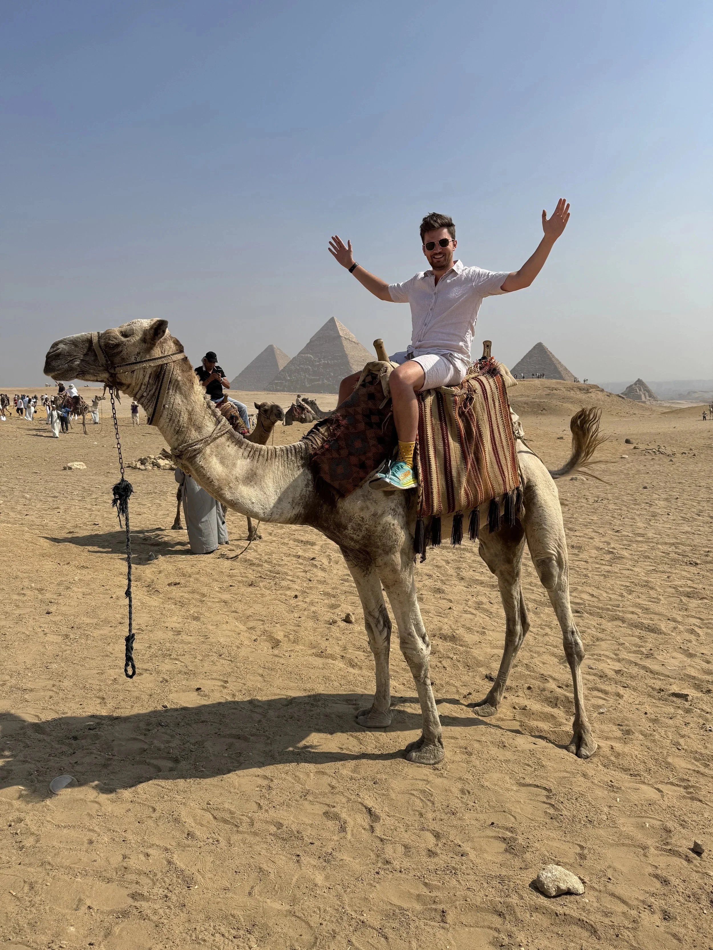 Giacomo at the pyramids on a camel