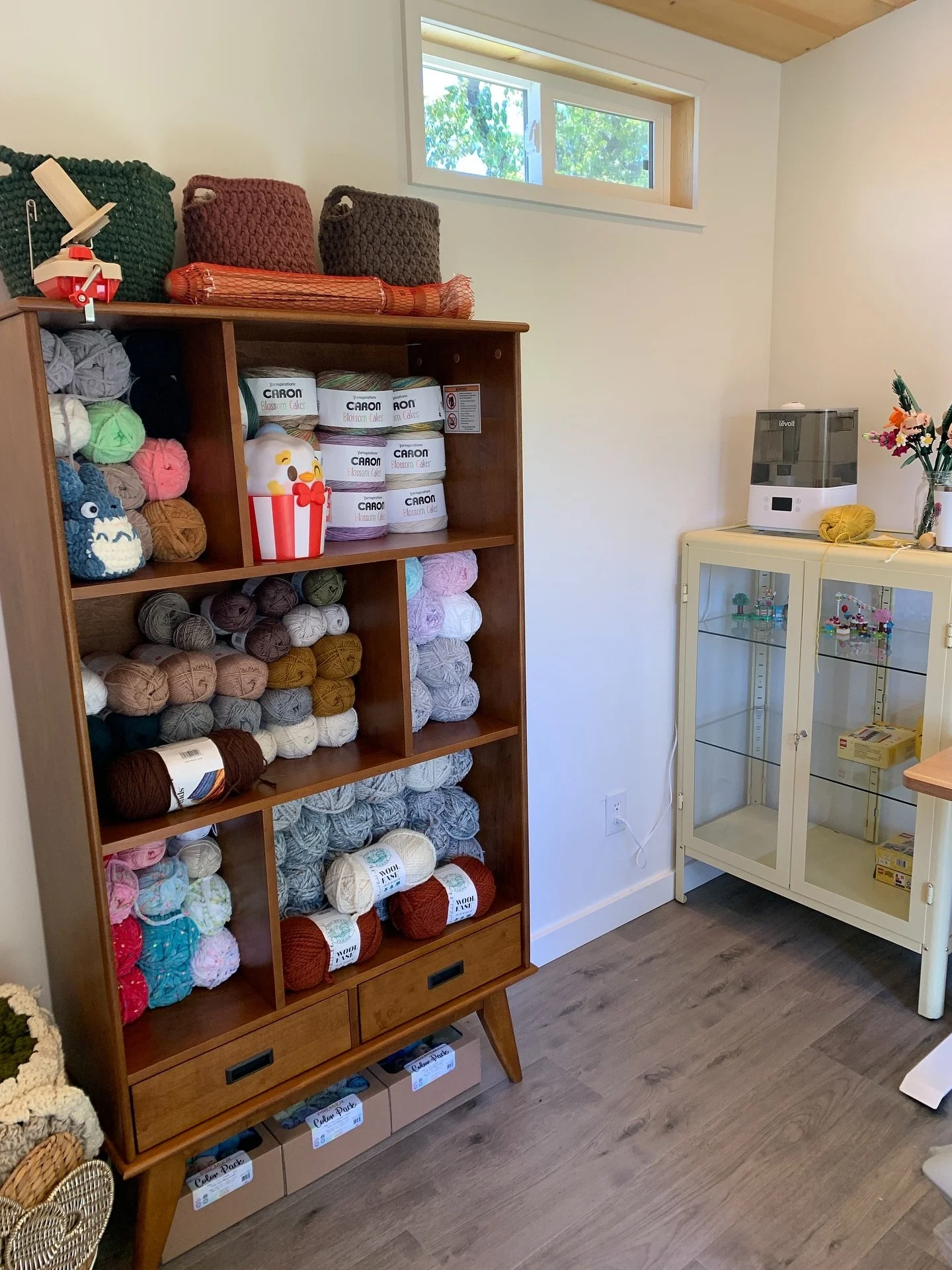 A cozy creative corner detail from one of our client studio sheds. Couldn&rsquo;t we all use this kind of organization in our lives?! 🧶🌈