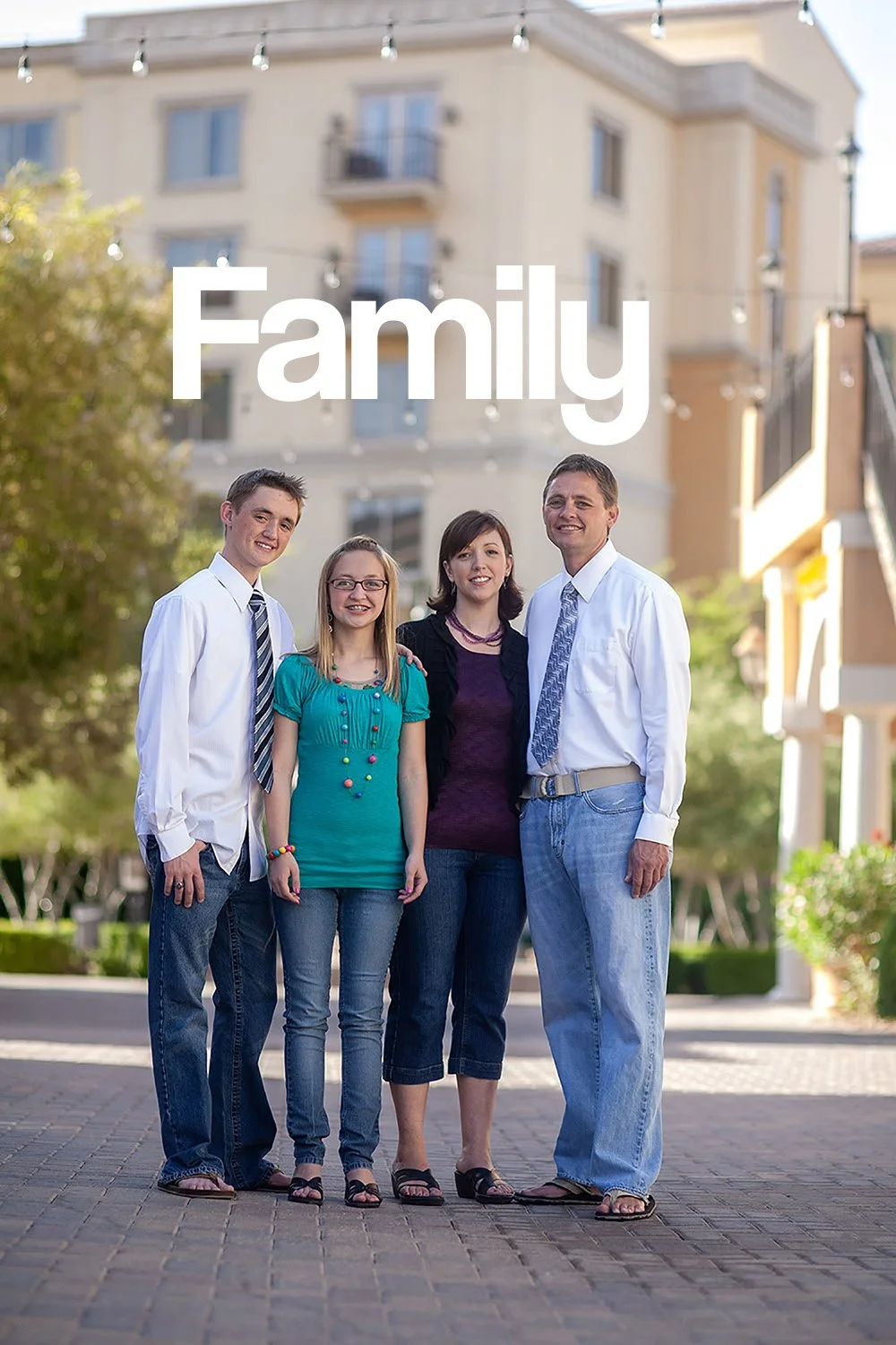 a family of a mom, dad, son and daughter standing on a brick road at Lake Las Vegas