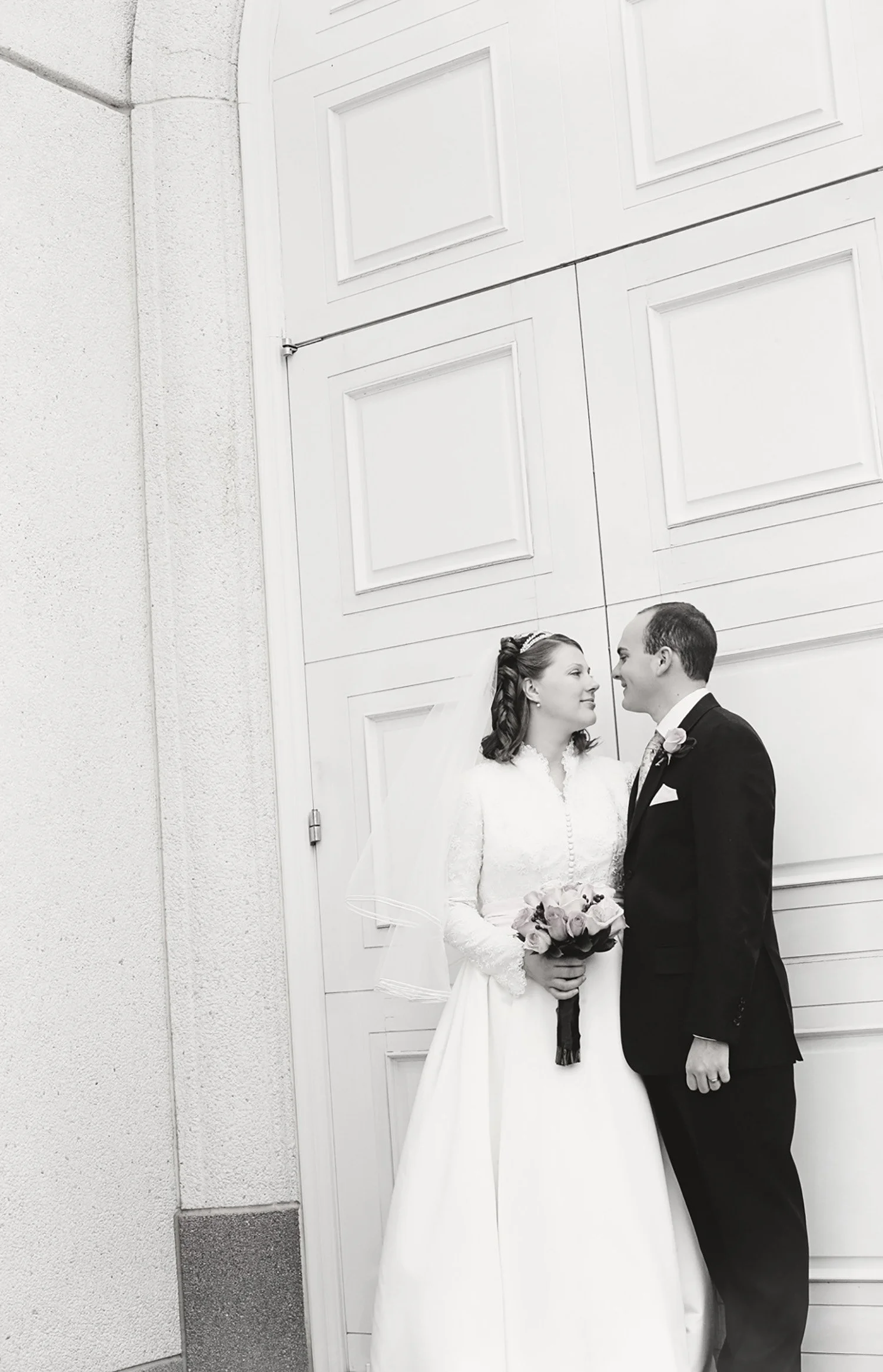 a black and white image of a bride and groom at the Las Vegas LDS Temple