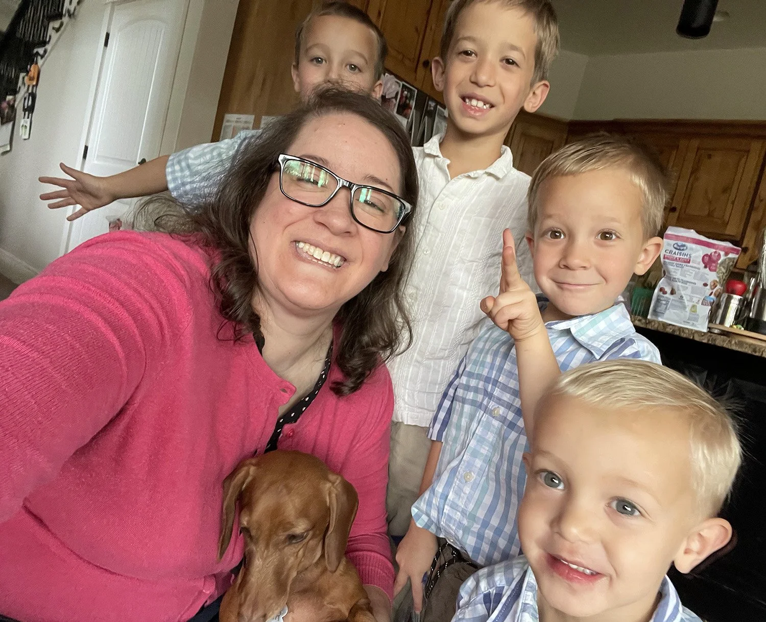 Lori taking a selfie with her four nephews and dog Walter