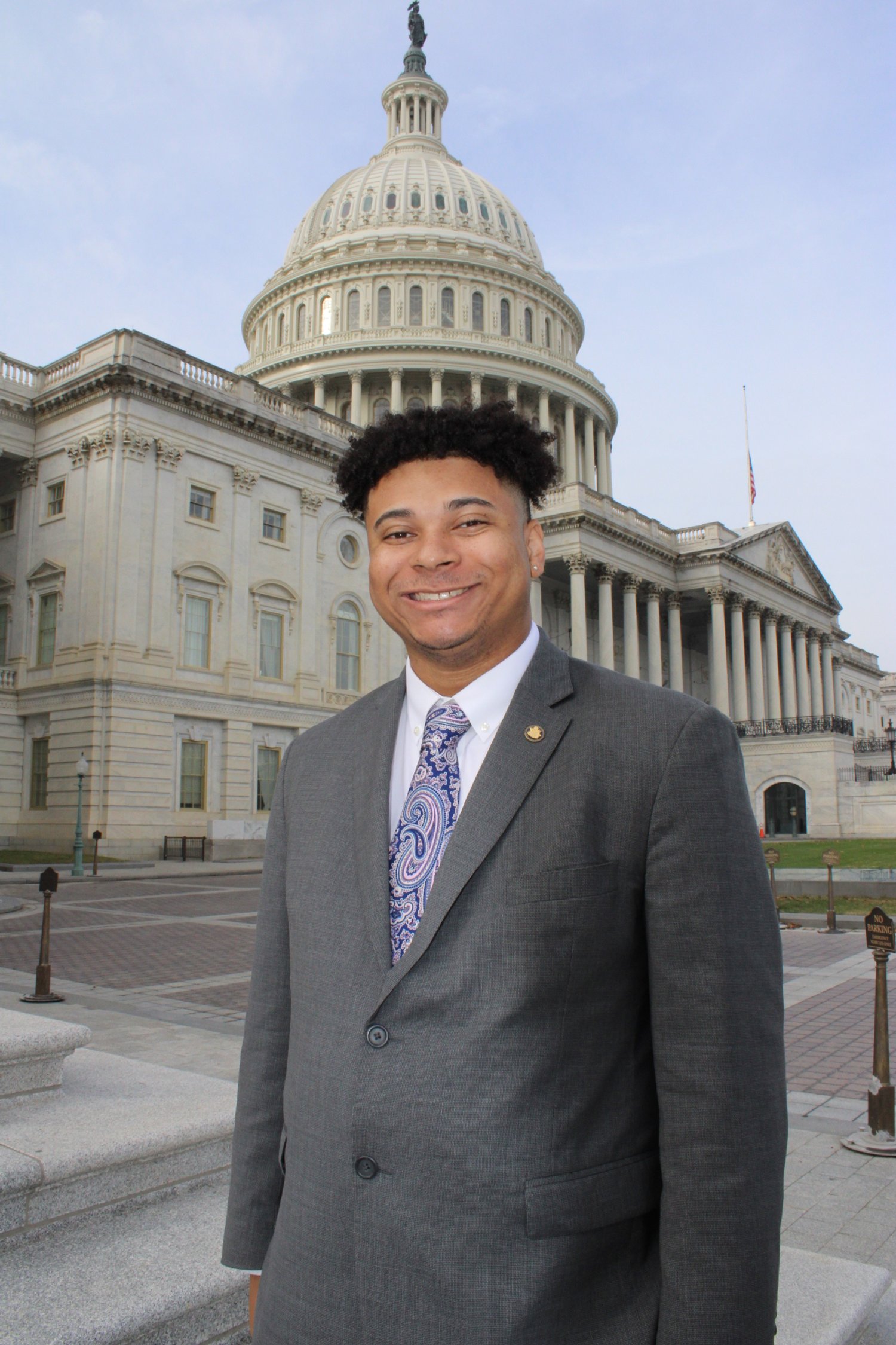 Justin Parker in suit in front of the U.S. Capitol building