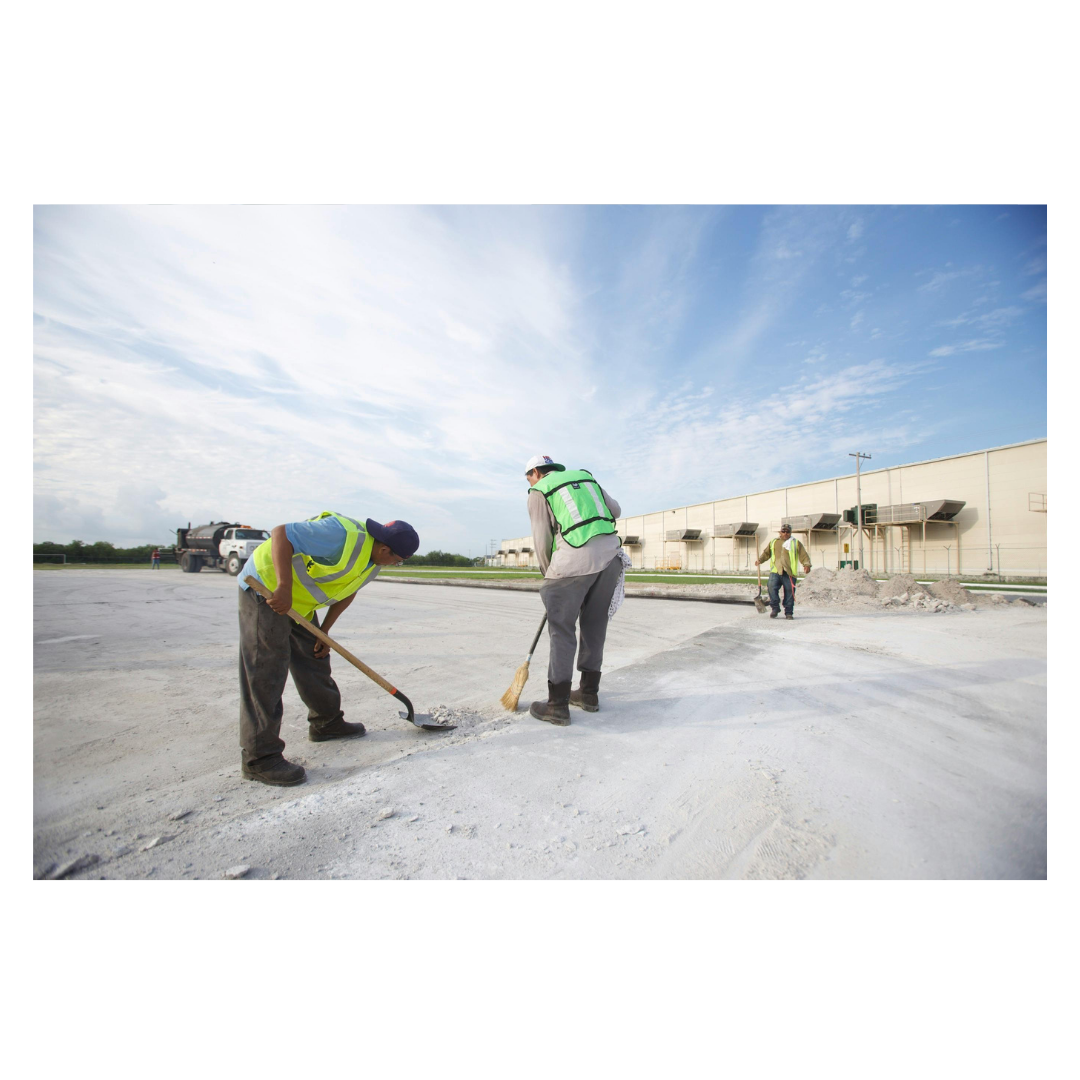 workers outdoors, laying concrete