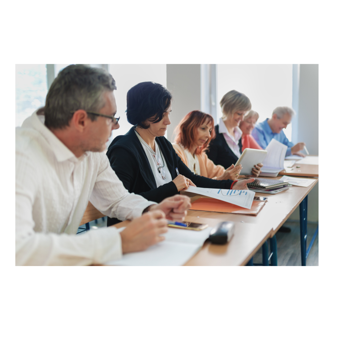 adults in a classroom, discussing a subject and learning together